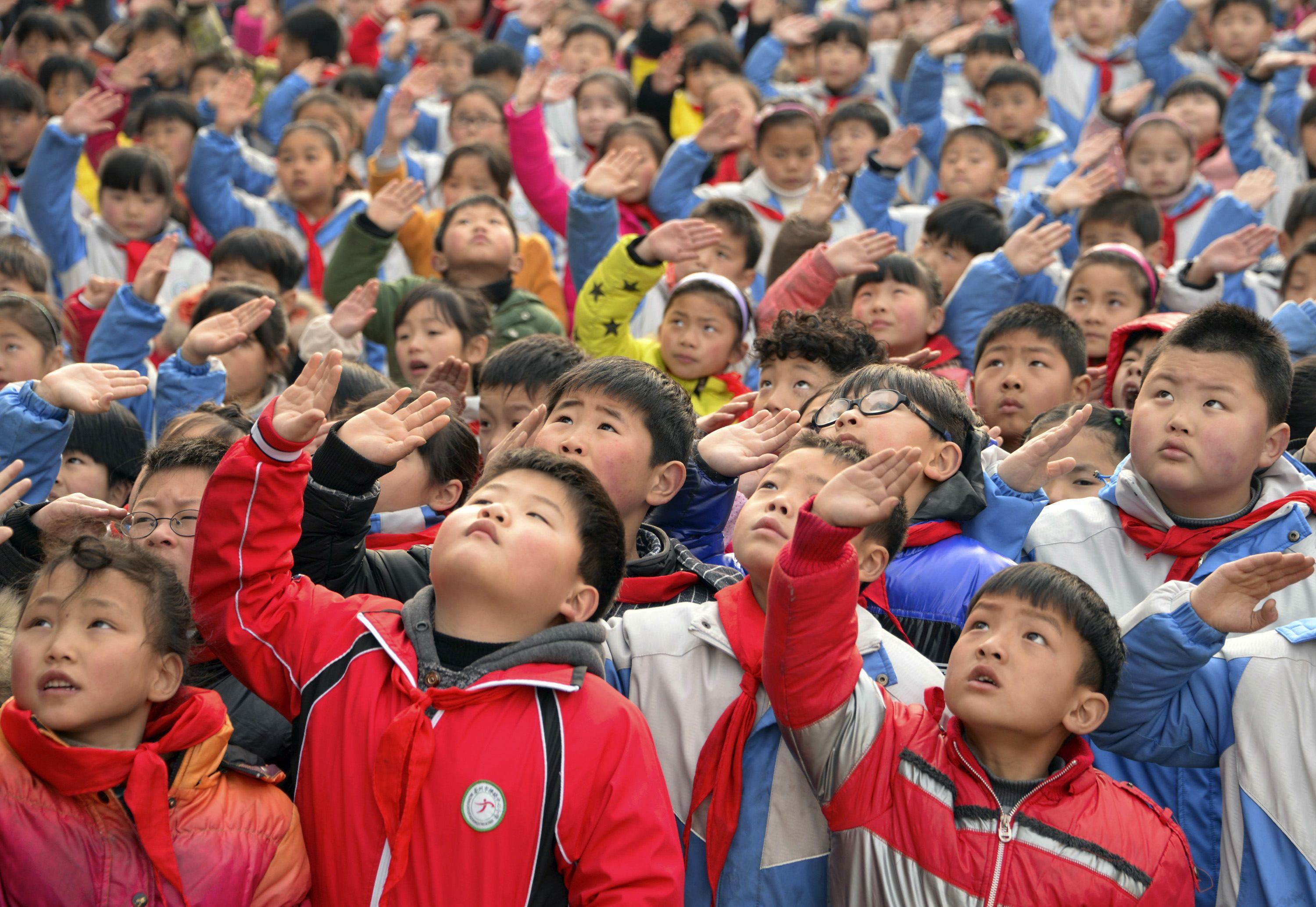 A primary school flag-raising ceremony. Pupils across the country will now face more classes designed to nurture a love for the party. Photo: Reuters
