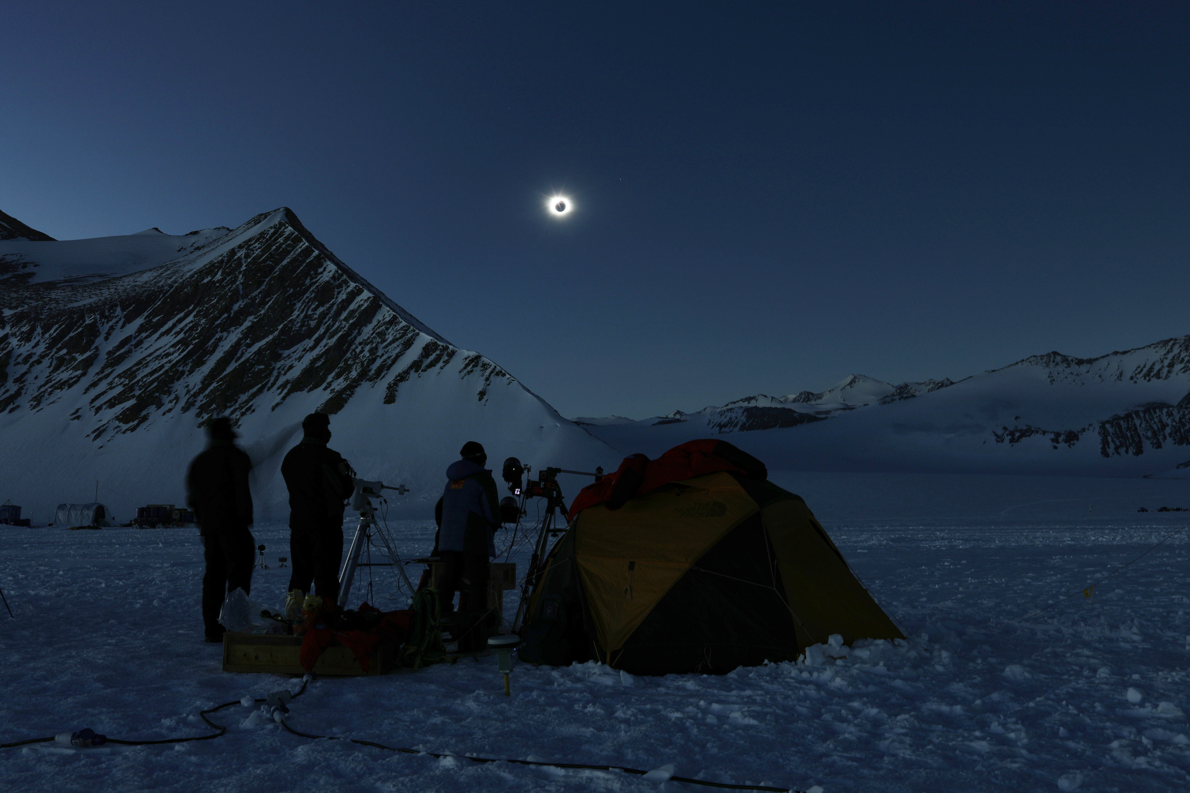 People view a total solar eclipse from Polar Union Glacier Camp in Antarctica on Saturday. Photo:  AP