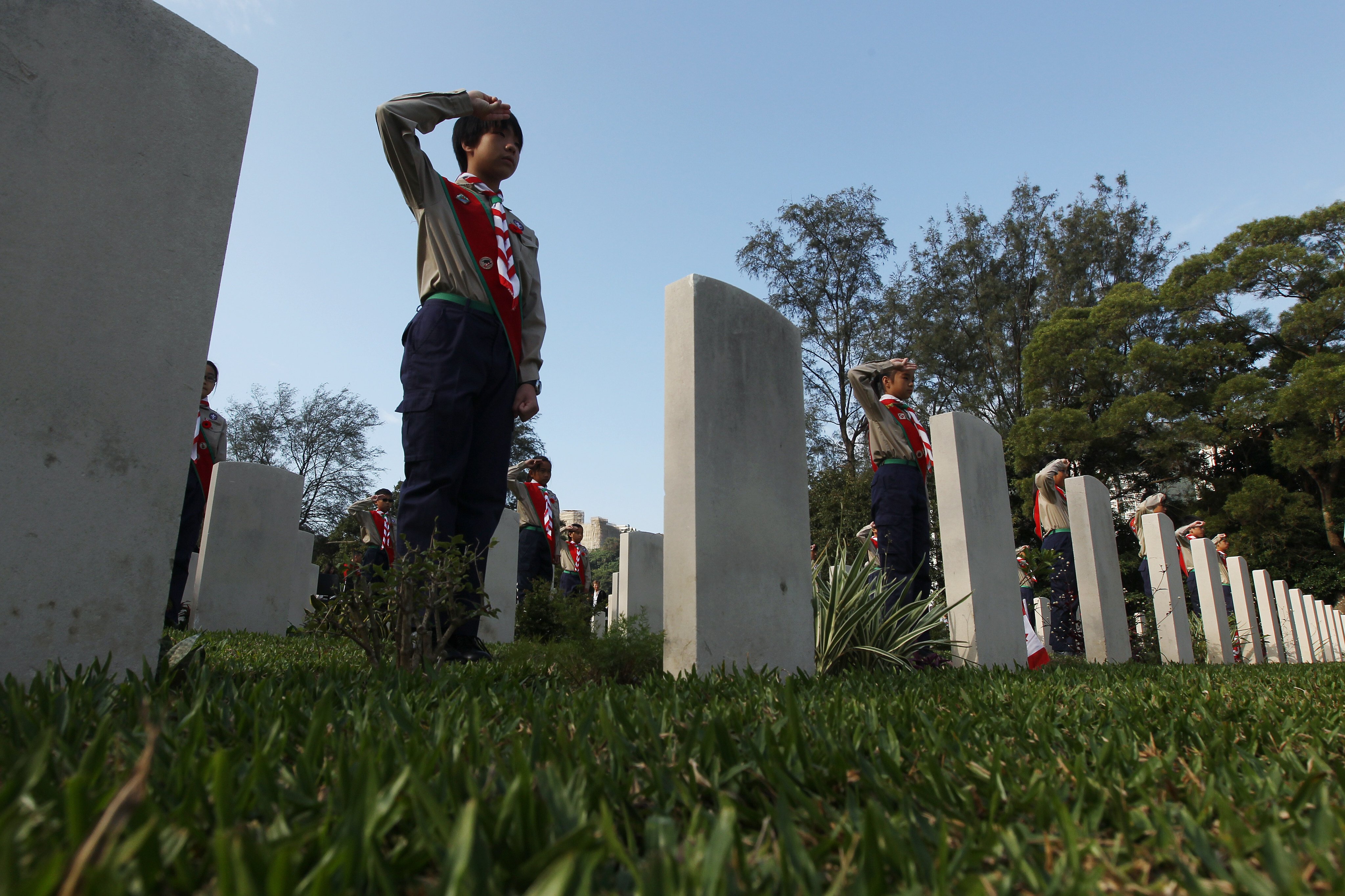 Boy scouts salute during a Canadian commemorative ceremony on the 70th anniversary of the Battle of Hong Kong, at Sai Wan War Cemetery in Chai Wan on December 4, 2011. In November 1941, two battalions from Canada arrived in Hong Kong to reinforce the local garrison. Photo: Sam Tsang