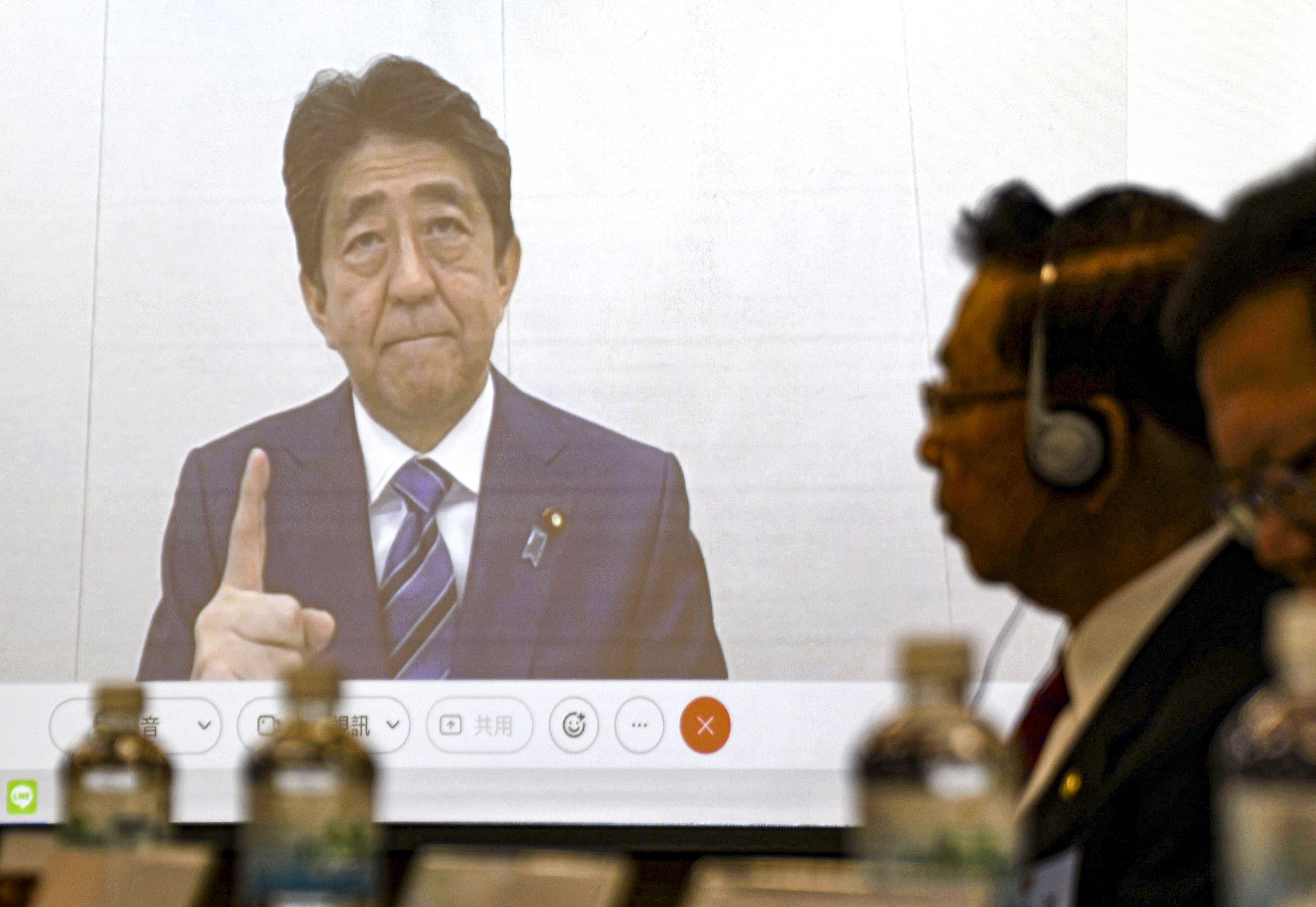Shinzo Abe appears on a screen during a meeting in Taipei on December  1. Beijing lashed out at Abe after the former Japanese prime minister warned of the serious security and economic consequences of any mainland military action against the self-ruled island. Photo: Kyodo