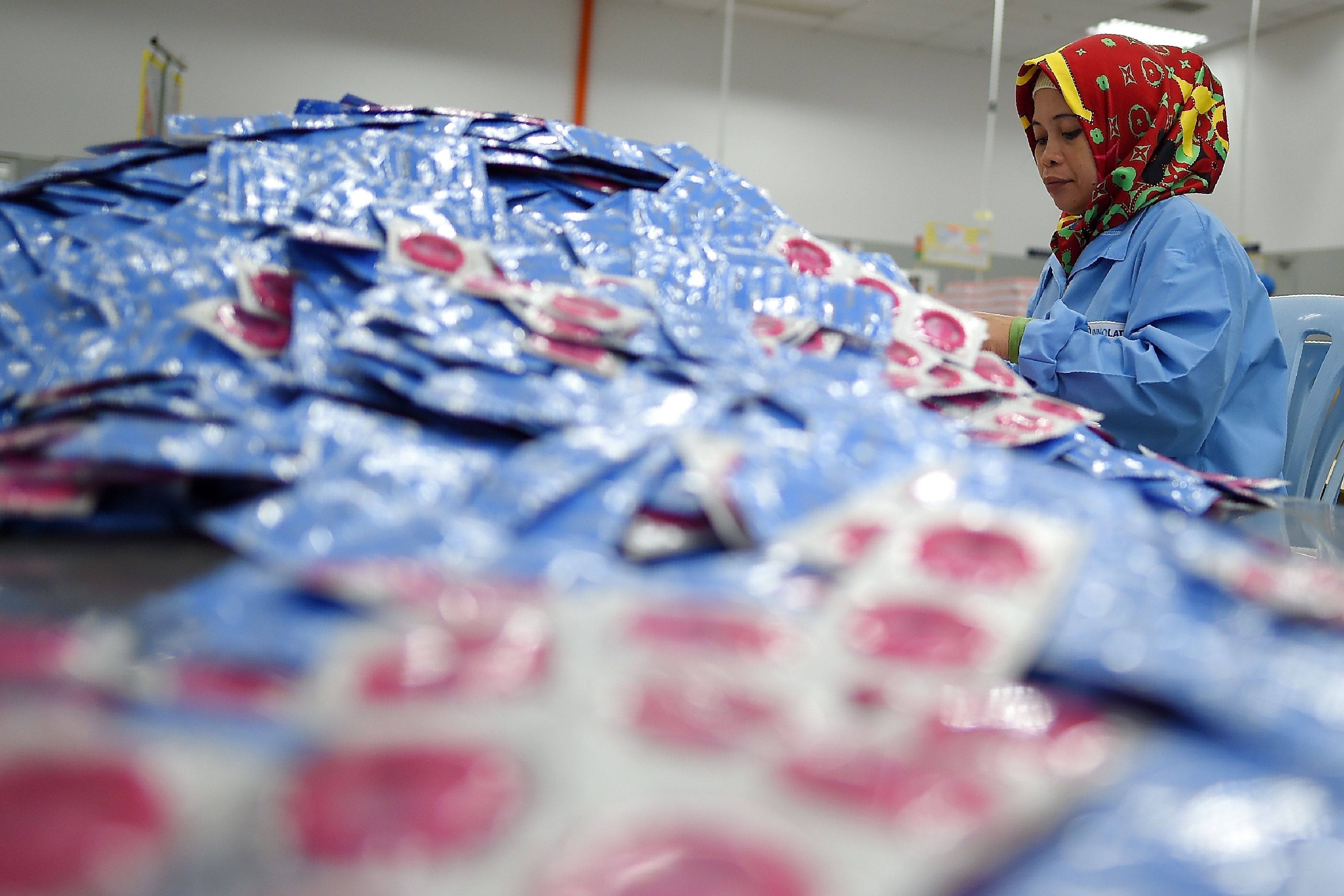 A worker packs condoms at the Malaysian condom-maker Karex Industries headquarters in Port Klang. Photo: AFP