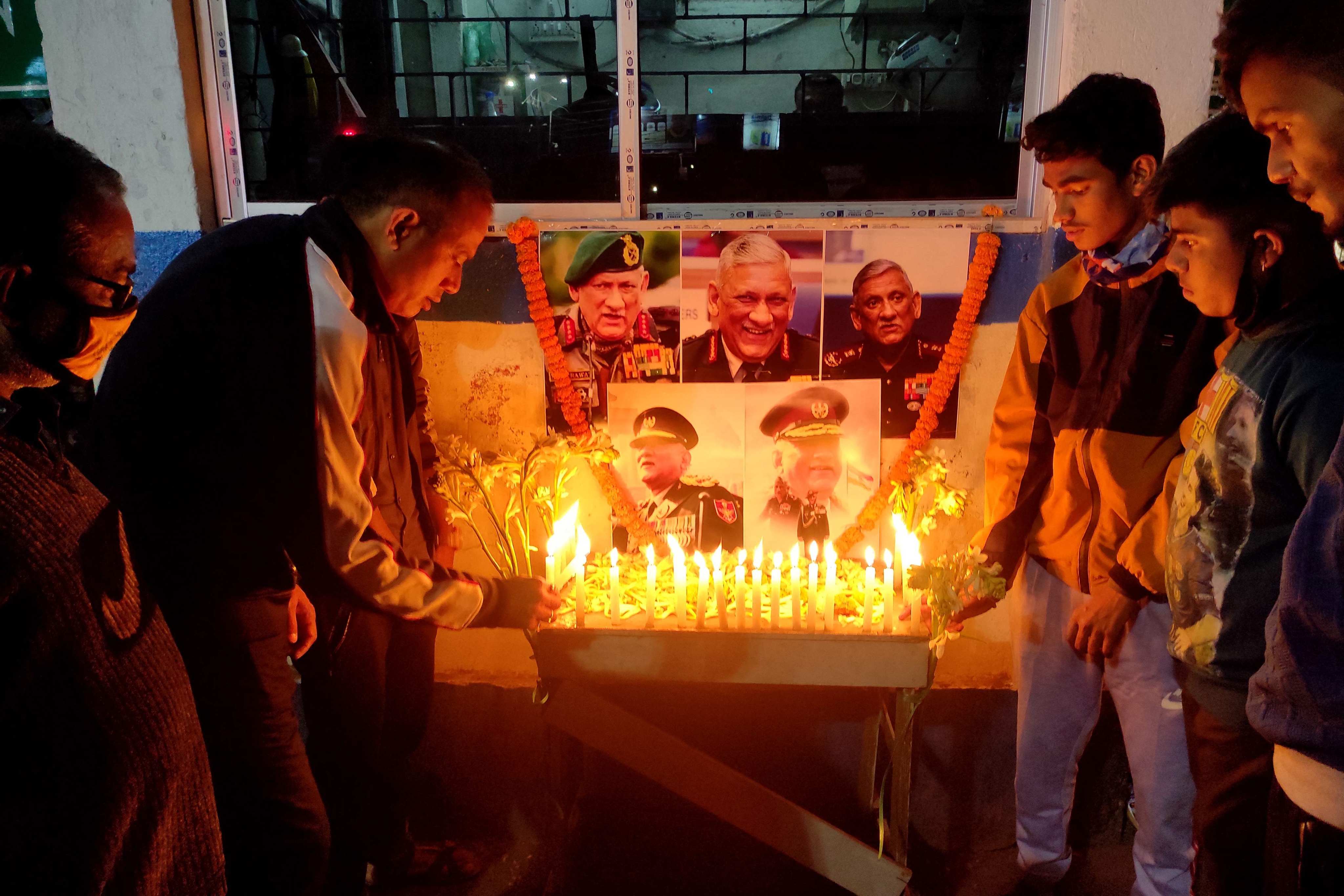 People light candles in front of a portrait of Indian defence chief General Bipin Rawat in Siliguri on Wednesday. Photo: AFP