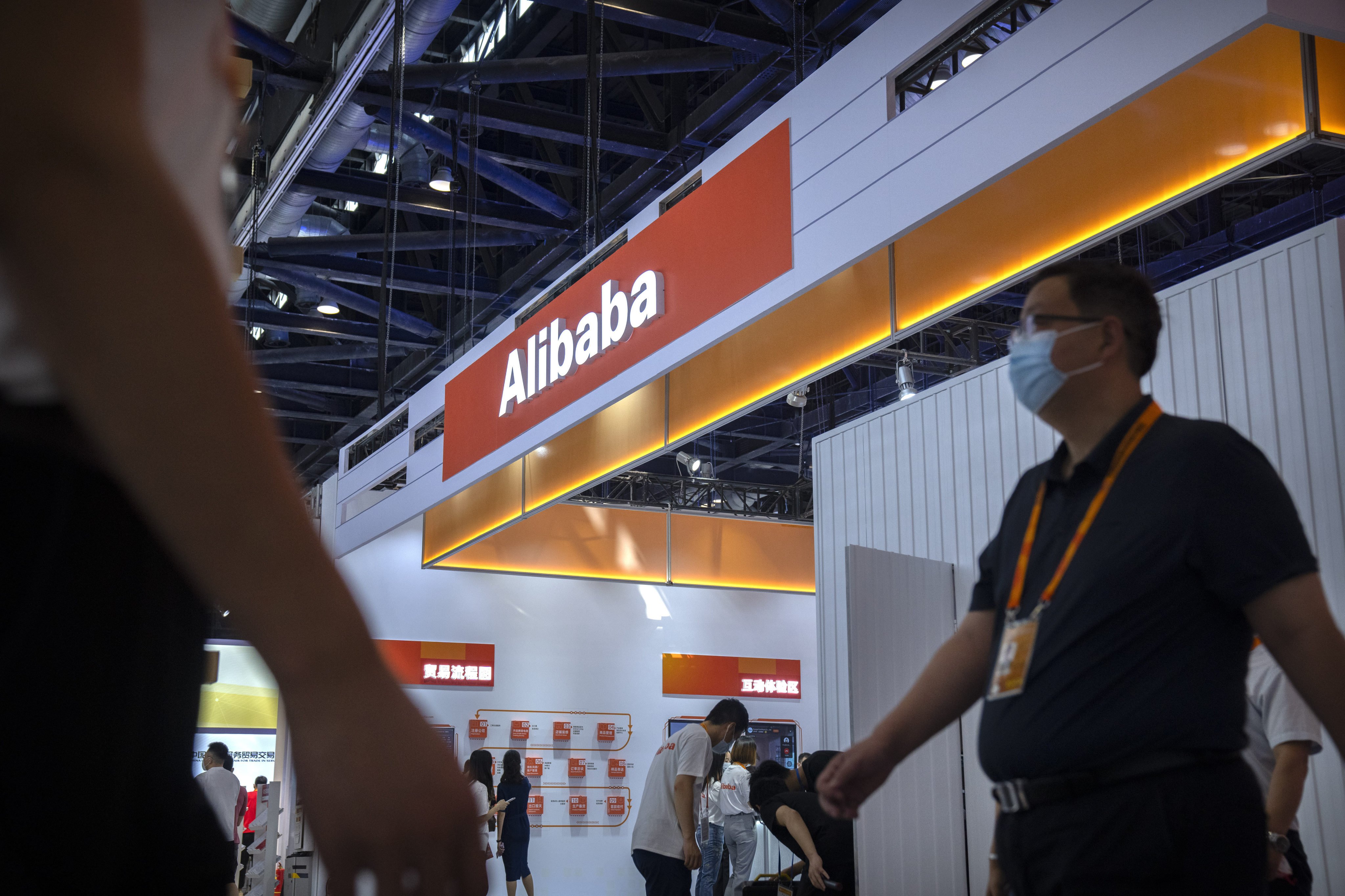 Visitors walk past a booth for Alibaba at the China International Fair for Trade in Services (CIFTIS) in Beijing, Sept. 3, 2021. Photo: AP
