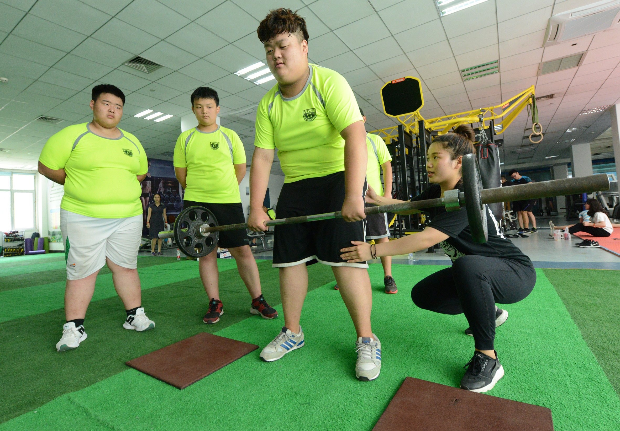Obese Chinese students do exercise under the guidance of a coach at a summer camp in Zhengzhou, Henan Province of China. Photo: Getty