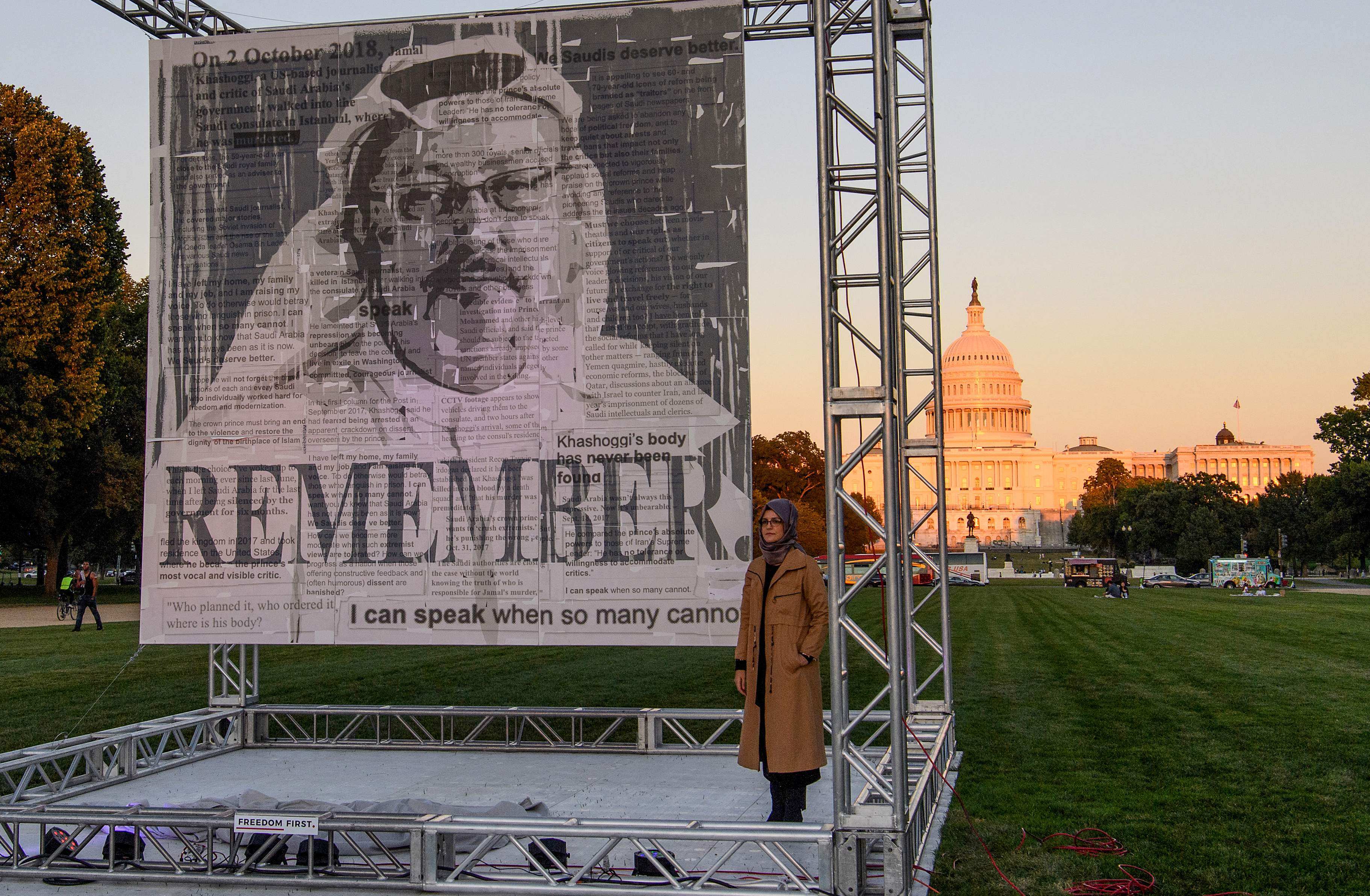 Turkish writer Hatice Cengiz, fiancée of Saudi journalist Jamal Khashoggi, poses next his portrait after unveiling it on the National Mall in Washington in October. Photo: AFP