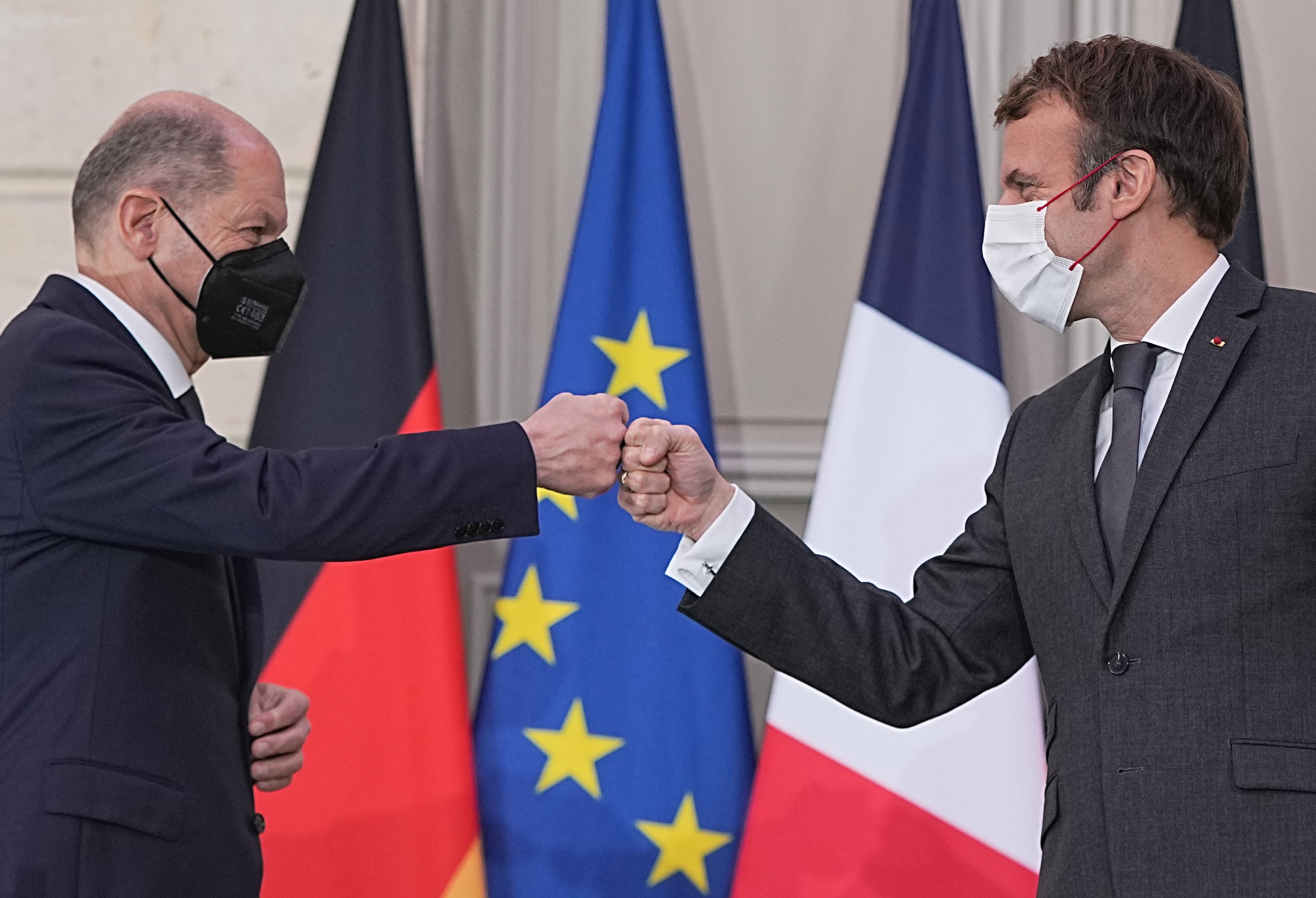 German Chancellor Olaf Scholz (left) and French President Emmanuel Macron fist bump at the end of their joint press conference at the Elysee Palace on Friday. Photo: dpa