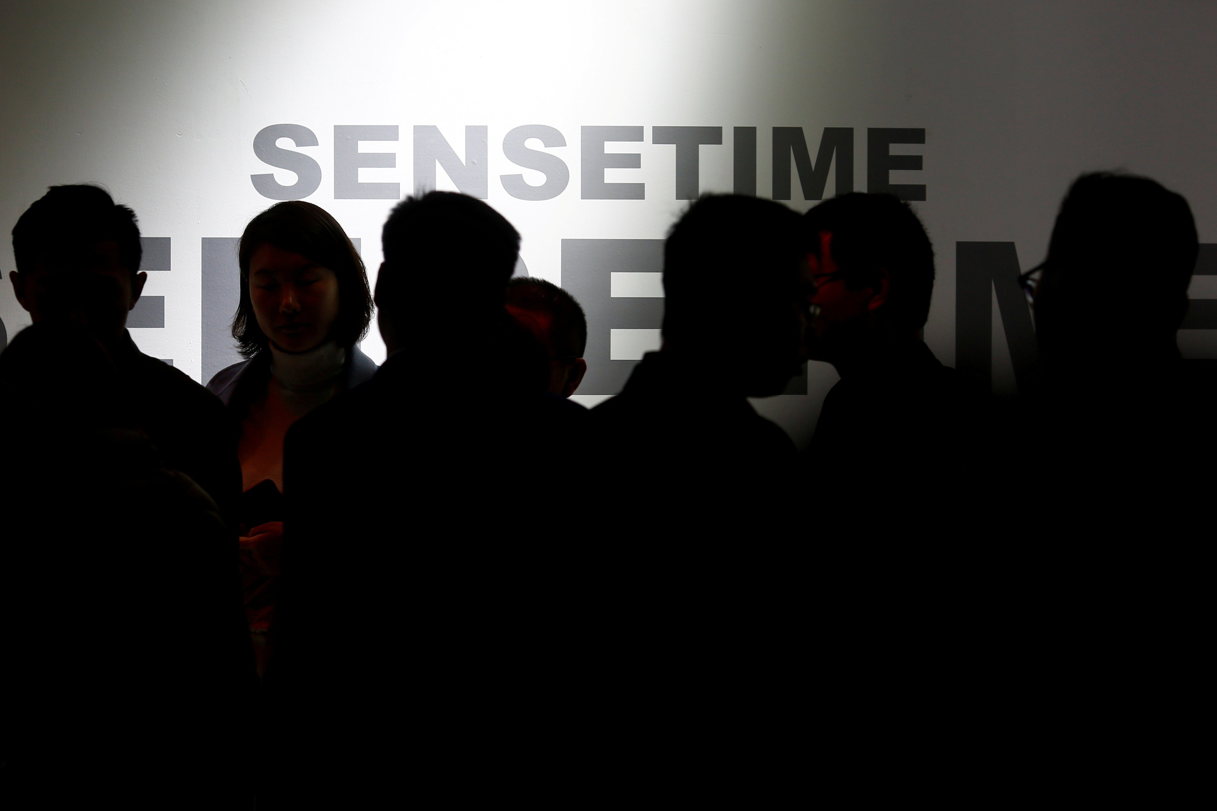 Visitors walk past the stall of artificial intelligence and facial recognition technology company SenseTime at the Security China 2018 exhibition in Beijing on October 23, 2018. Photo: Reuters