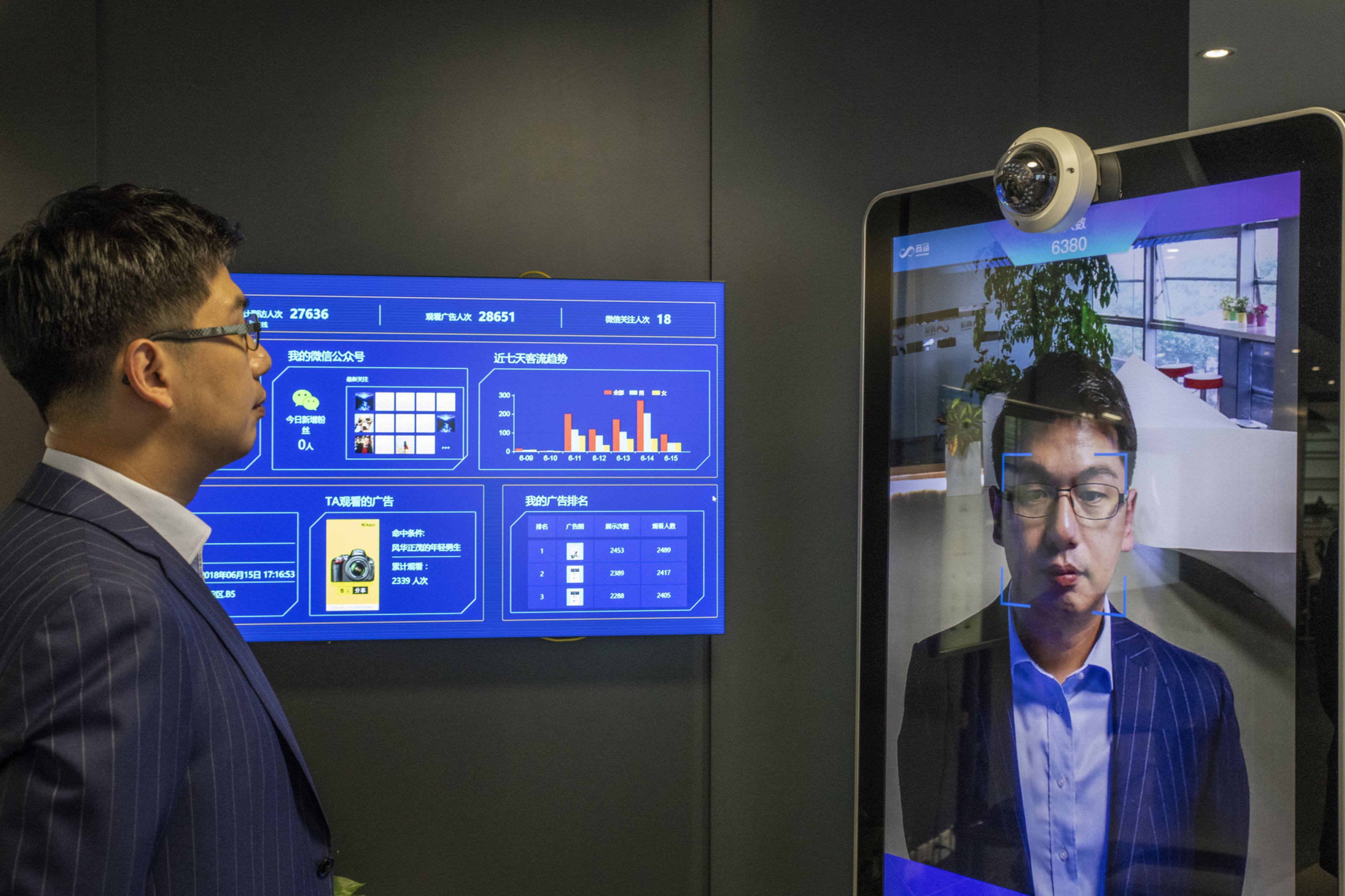 Xu Li, chief executive officer of SenseTime Group Ltd., is identified by the company’s facial recognition system on a screen as he poses for a photograph at SenseTime’s showroom in Beijing in 2018. Photo: Bloomberg