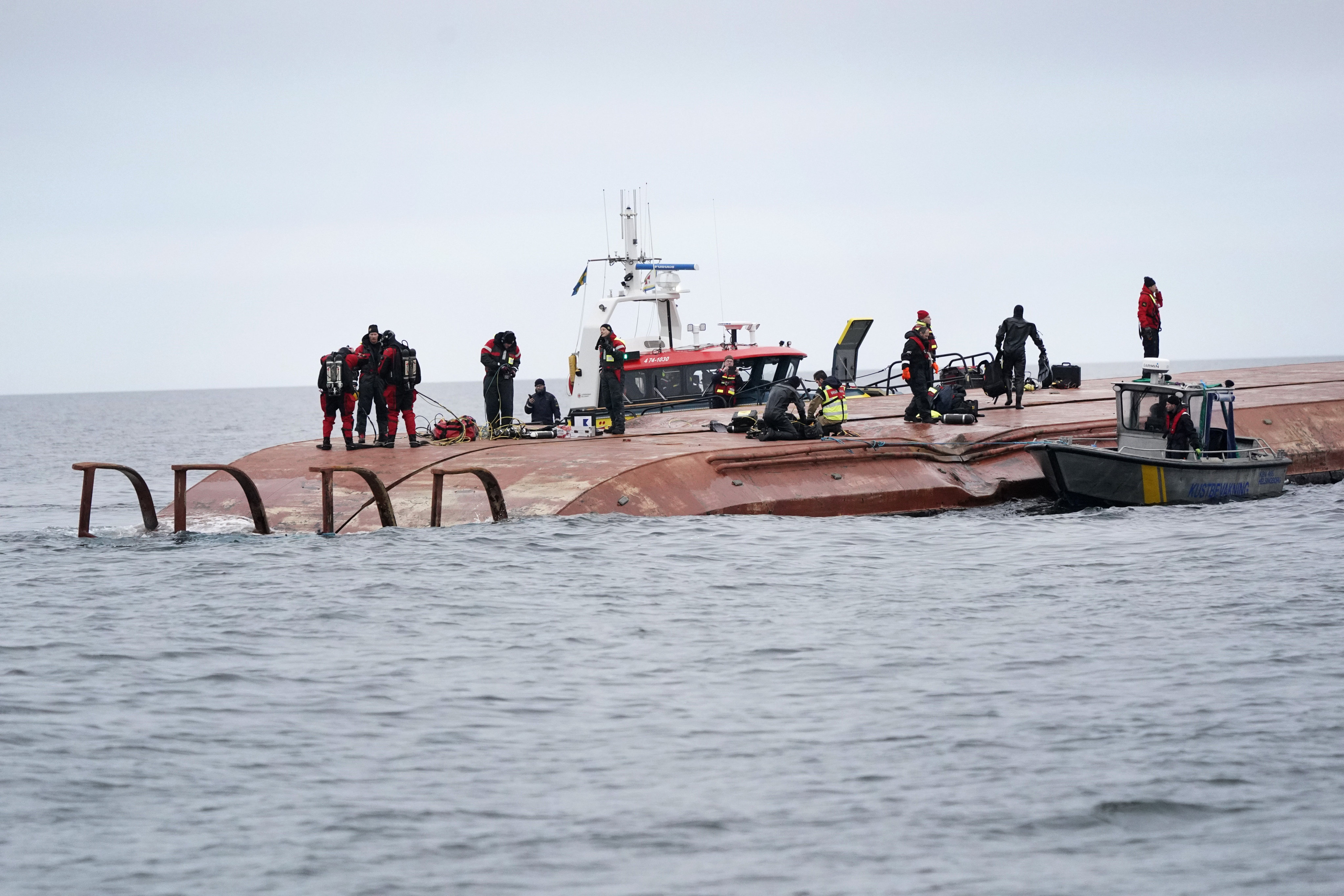 Divers work on the capsized Danish cargo ship Karin Hoj after it collided with British cargo vessel Scot Carrier in the Baltic Sea on Monday. Photo: AP