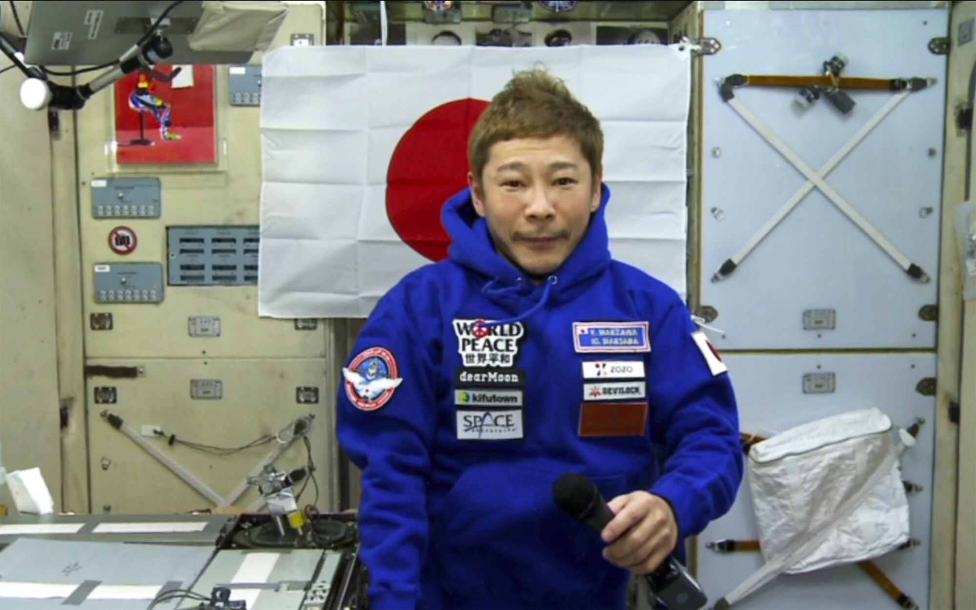 Yusaku Maezawa defends his extravagant expense, speaking to journalists on December 13. Photo: Roscosmos Space Agency via AP