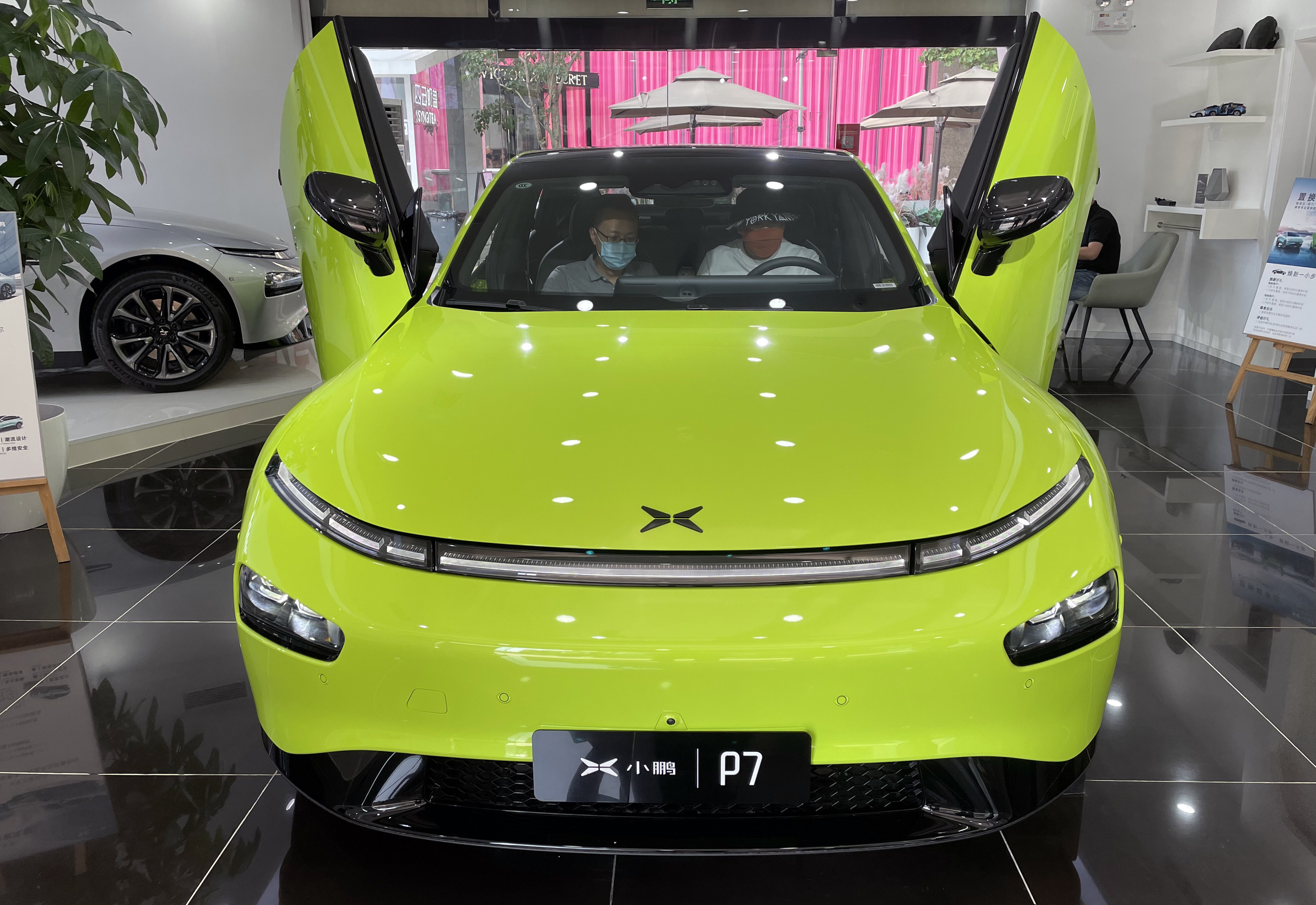 Two consumers check out an Xpeng P7 intelligent electric car at the company’s showroom in Beijing. Photo: Simon Song