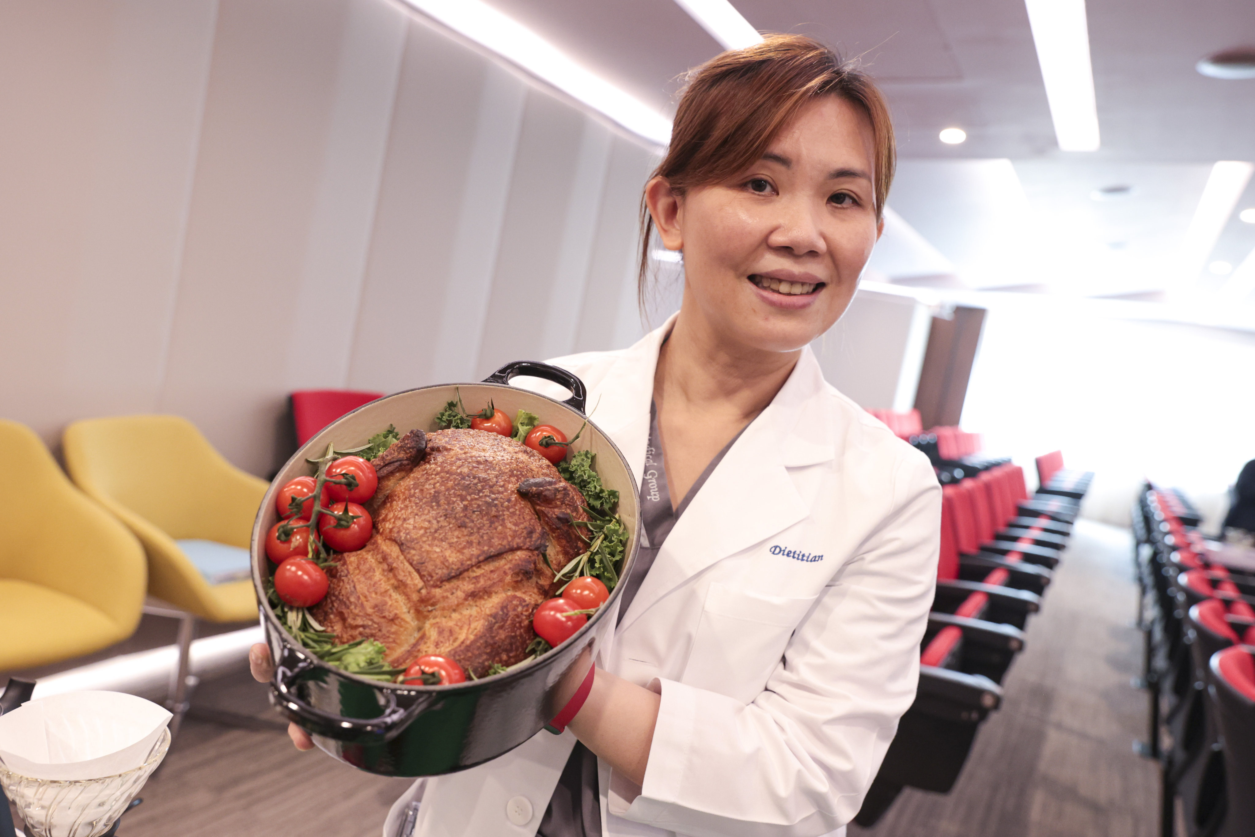 Dietitian June Chan holds her sourdough bread shaped like a Christmas turkey at the OSC fundraiser at Hong Kong Sanatorium and Hospital. Photo: Sam Tsang