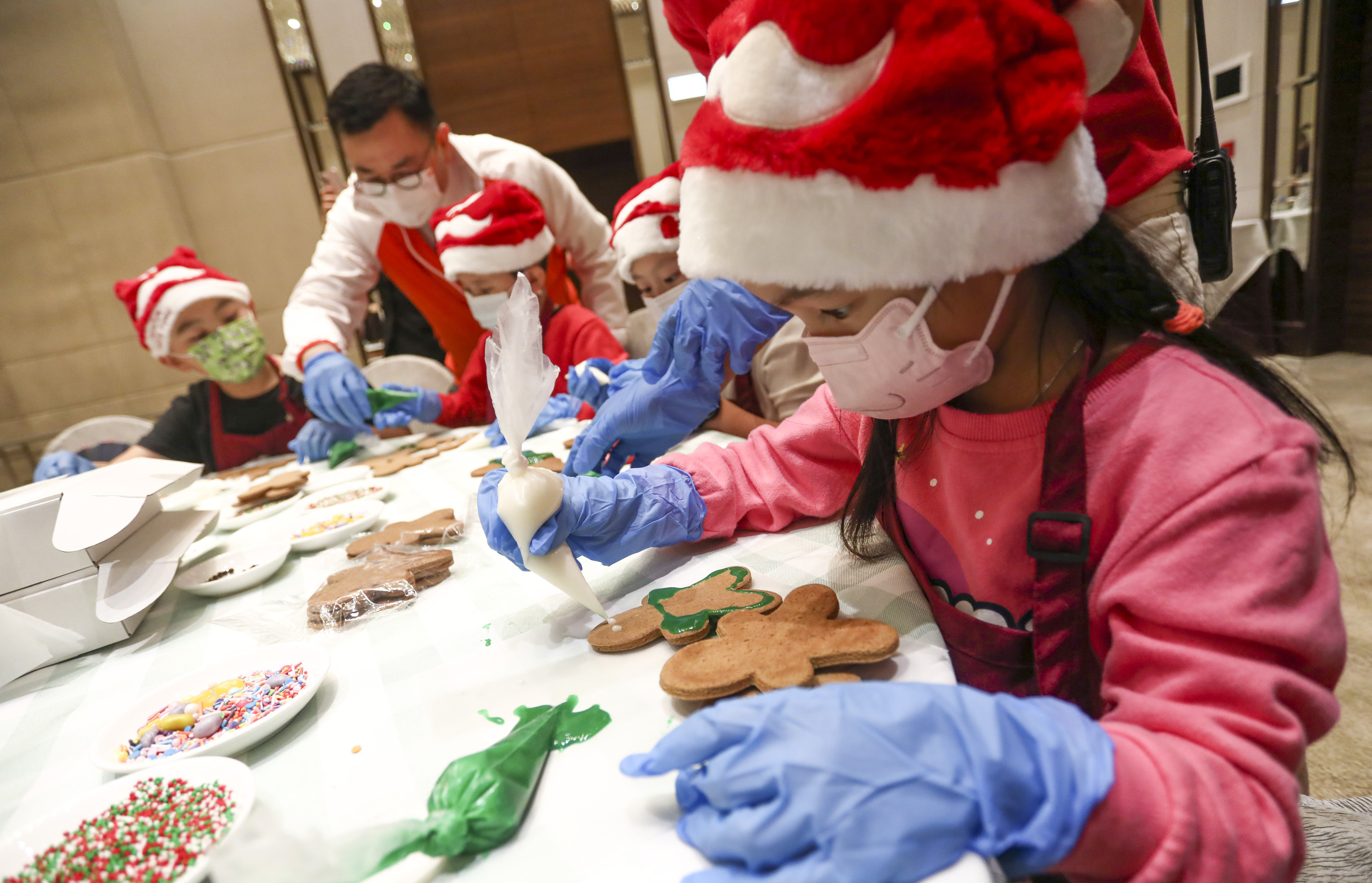 The Hong Kong Gold Coast Hotel last month welcomed 15 children from underprivileged familes for a day of Christmas activities, including making gingerbread men. Photo: Jonathan Wong