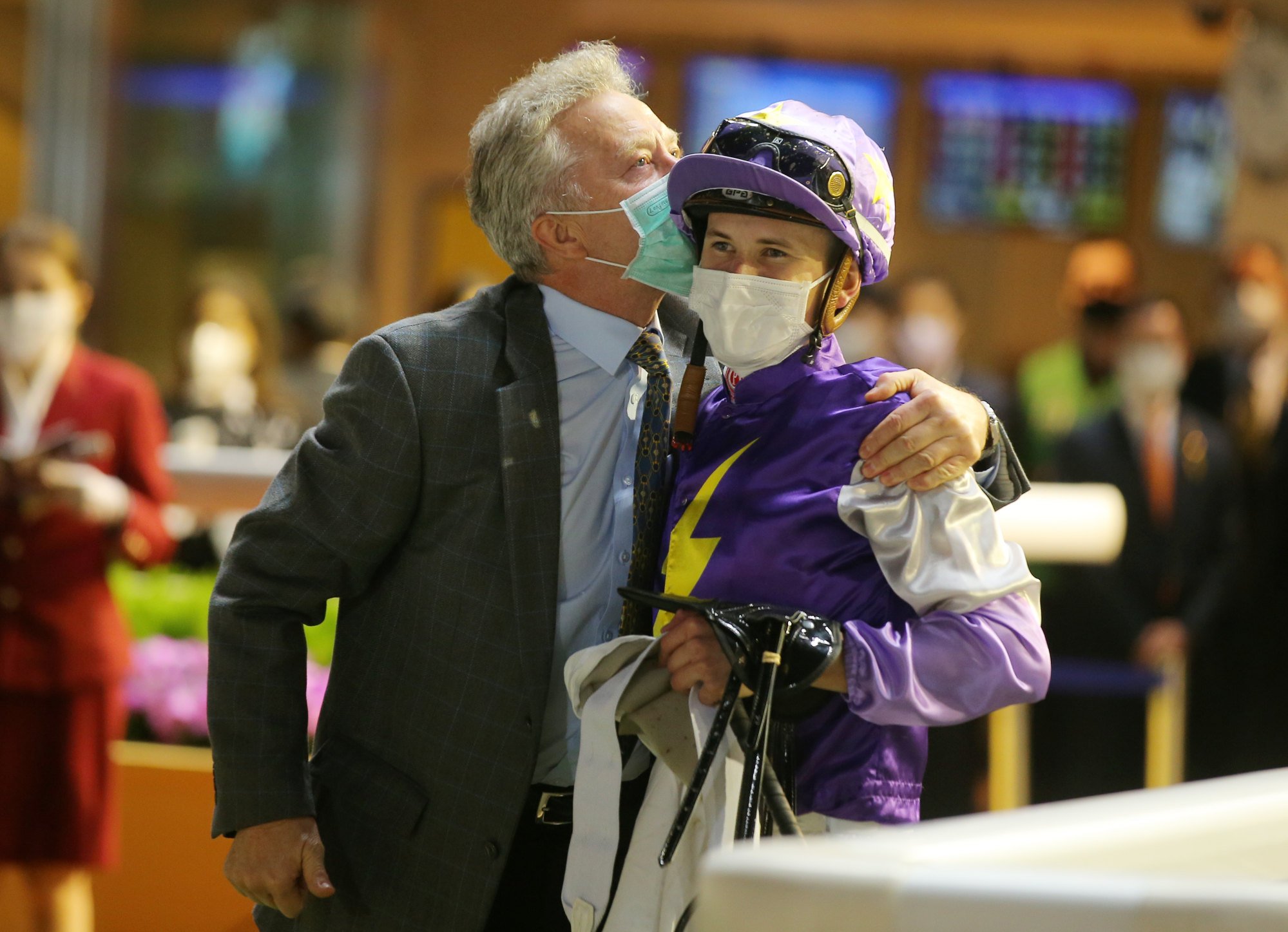 Trainer David Ferraris gives son Luke a kiss after a winner.