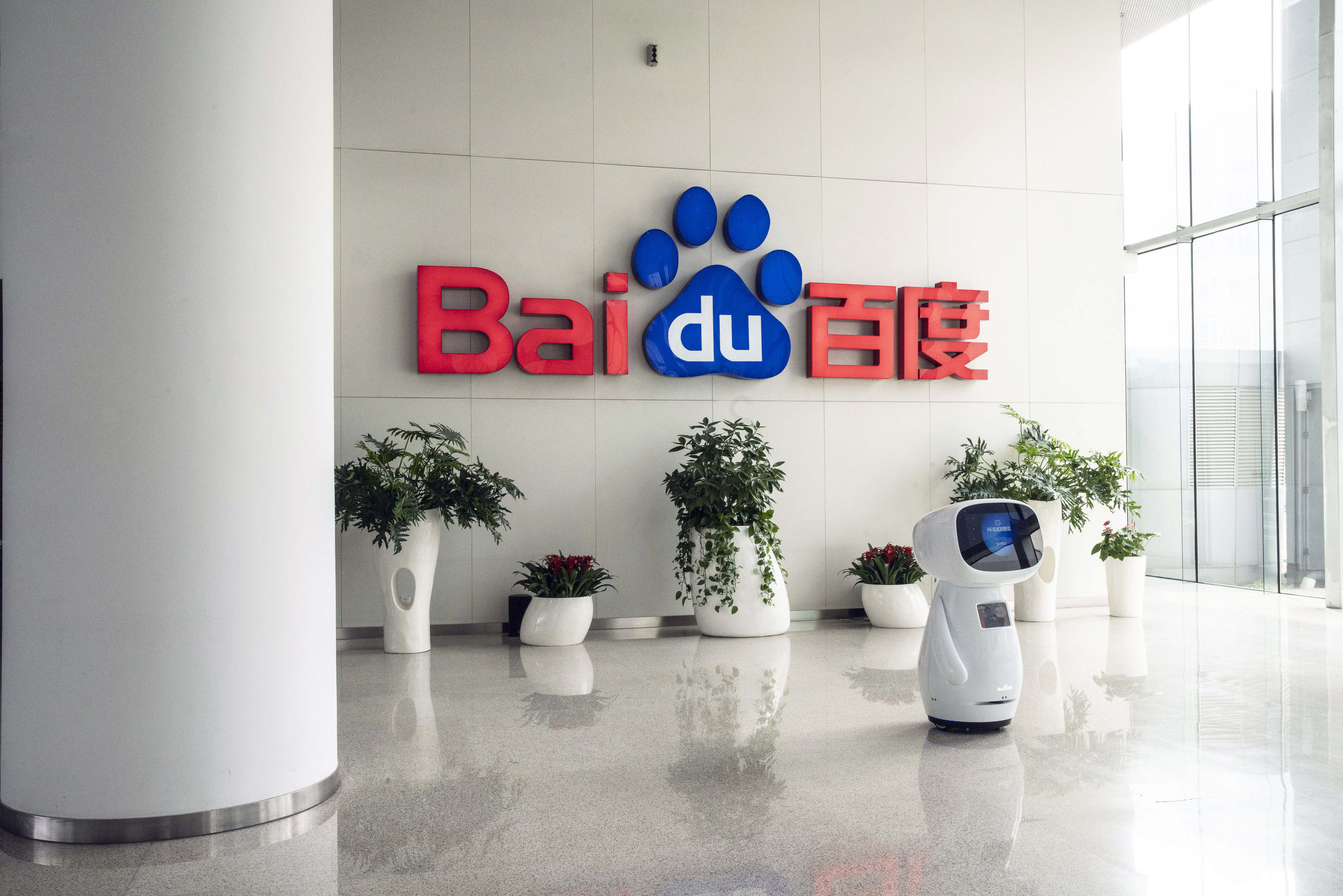 An artificial intelligence (AI) robot seen in front of the the Baidu logo at the company’s headquarters in Beijing, March 4, 2021. Photo: Bloomberg
