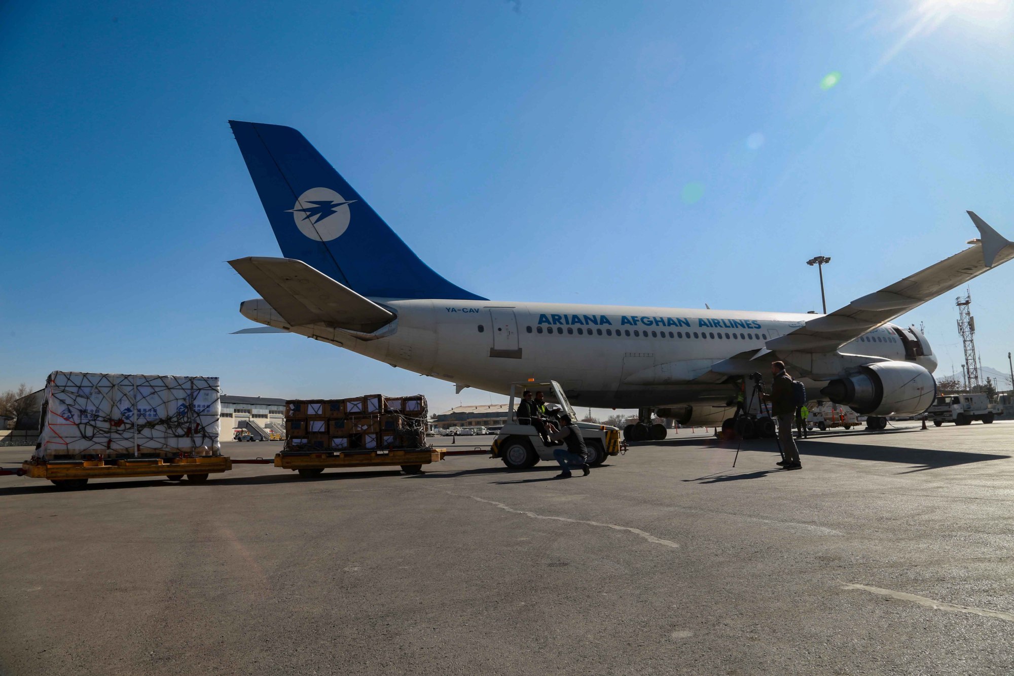 Workers unload Covid-19 vaccines donated by China at Kabul airport in Afghanistan. Photo: EPA-EFE