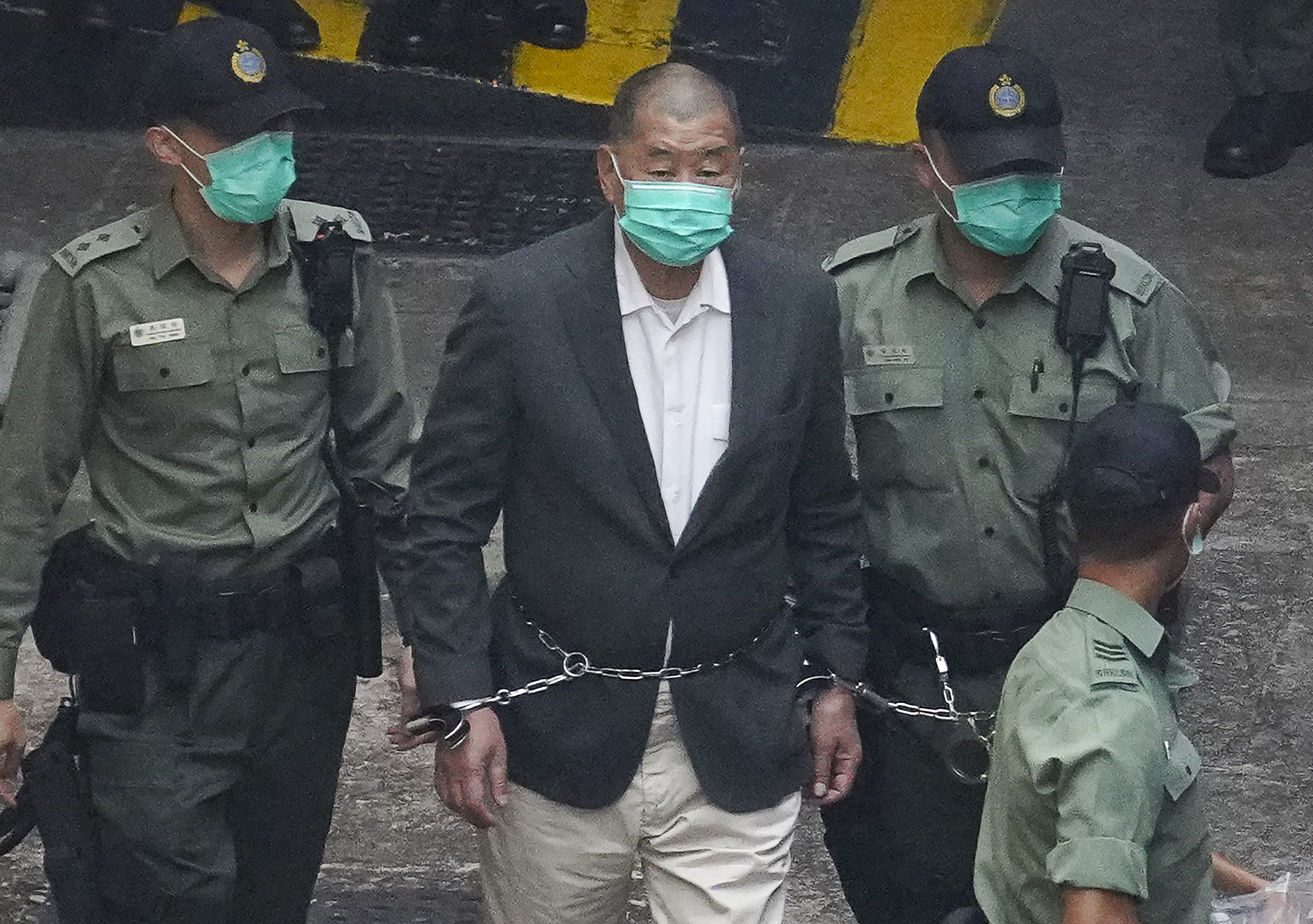 Media mogul Jimmy Lai is escorted to a prison van en route to a court appearance last year. Photo: Winson Wong