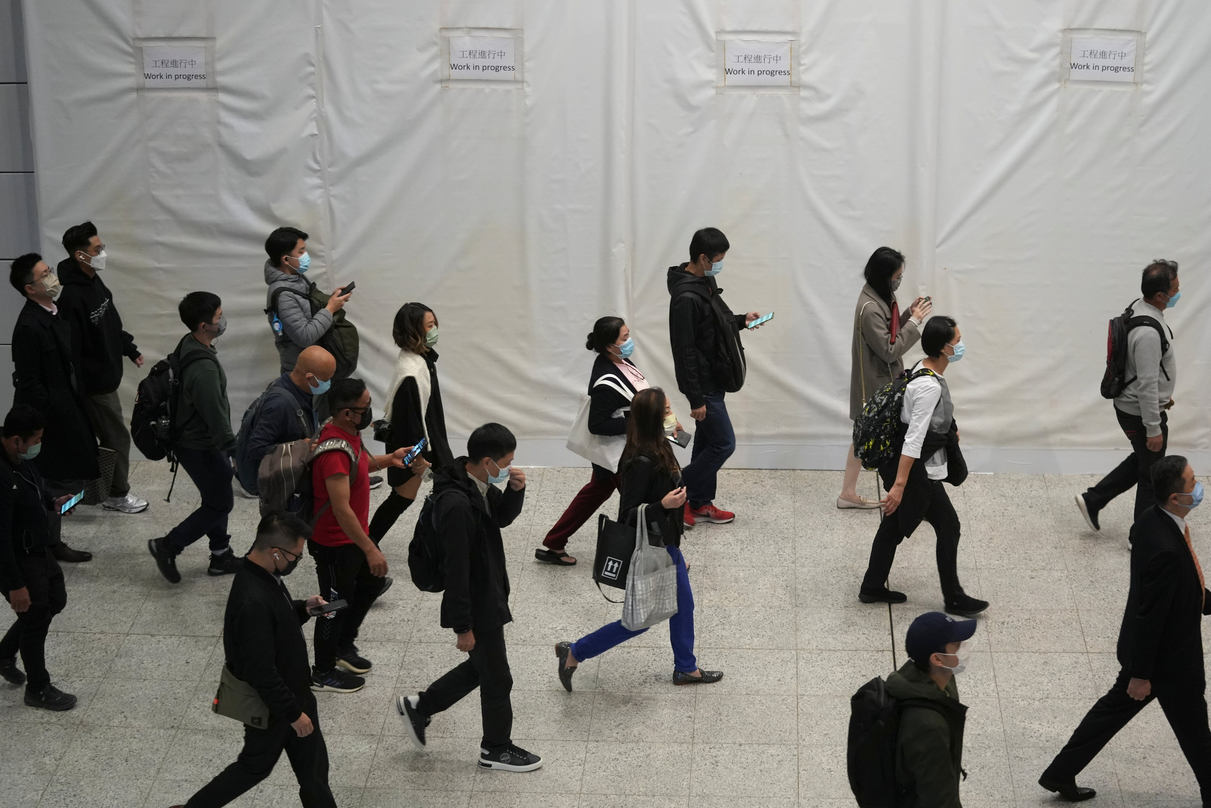 Commuters wearing masks to prevent the spread of the coronavirus disease walk through an MTR station in Hong Kong on December 1. Photo: Reuters 
