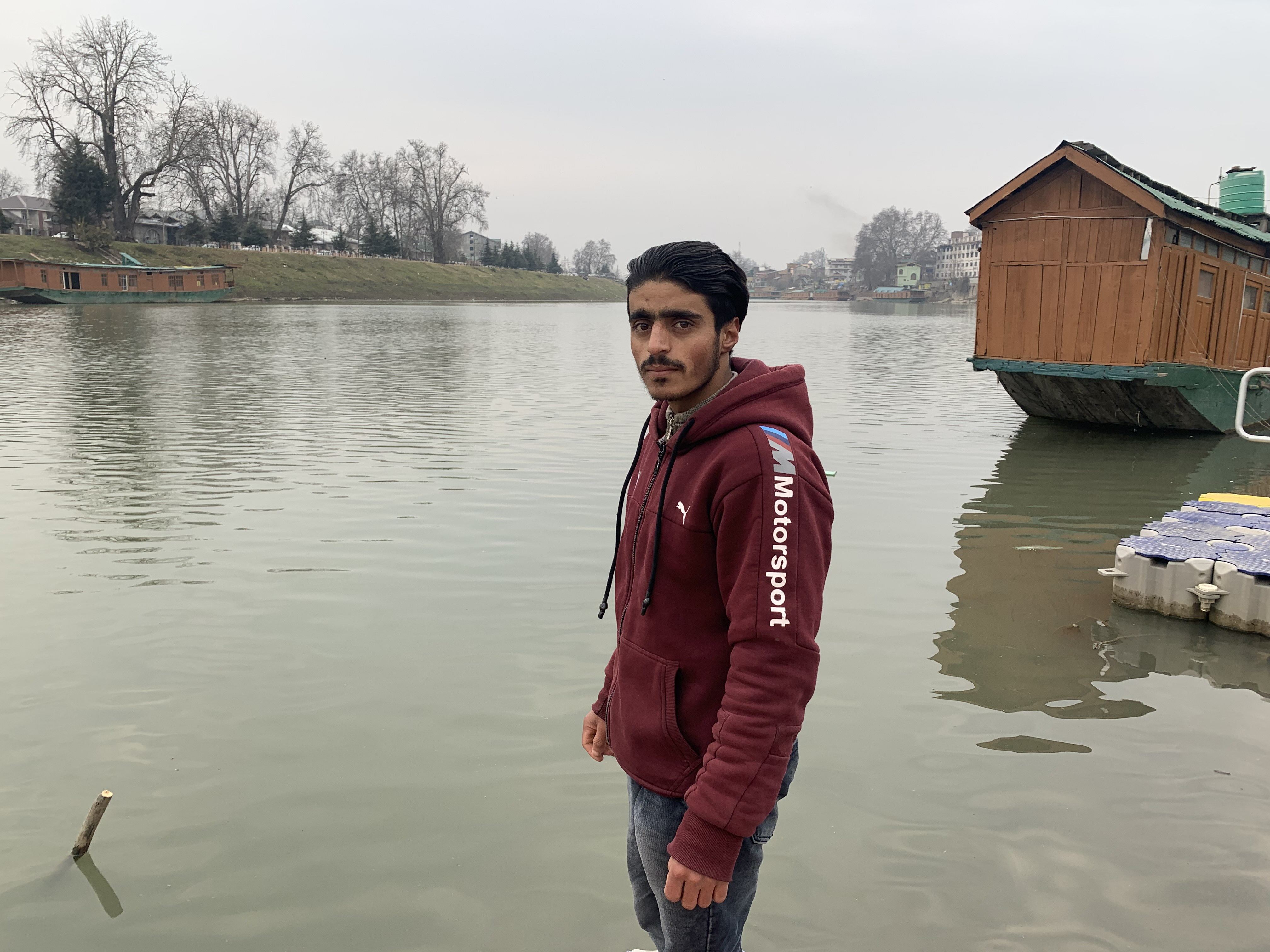 Bilal Ahmad Dar stands at the bank of the Jhelum river in the evening after finishing his Covid-19 duties for the day. Photo: Adnan Bhat