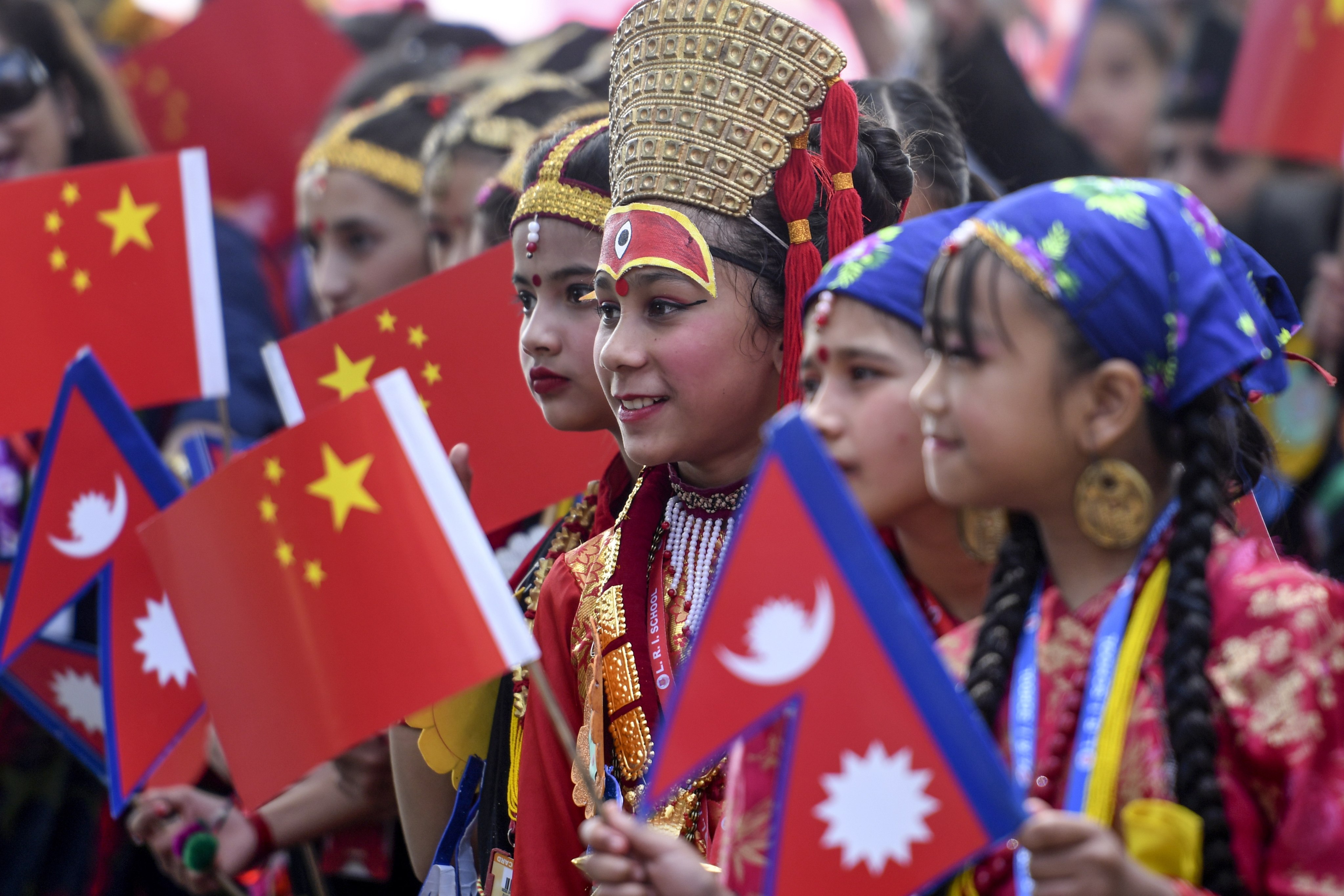Nepali children wearing traditional clothes at Tribhuvan International Airport bid farewell to China’s President Xi Jinping after his two-day visit in 2019. Photo: EPA