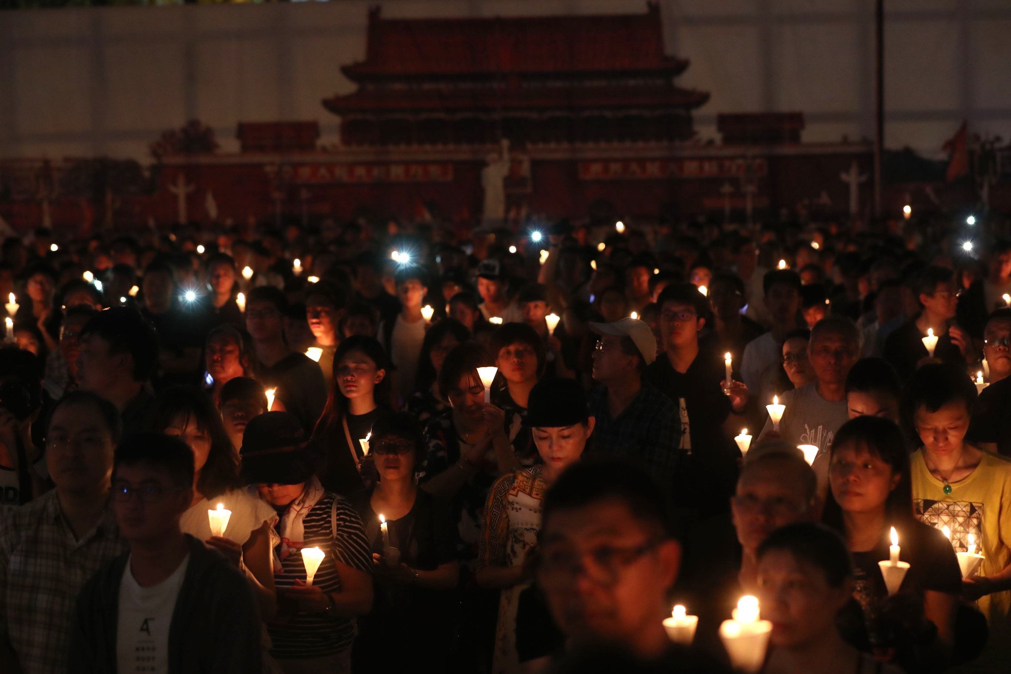 People raising their candles during the June 4 candlelight vigil at Victoria Park in 2019. Photo: Sam Tsang