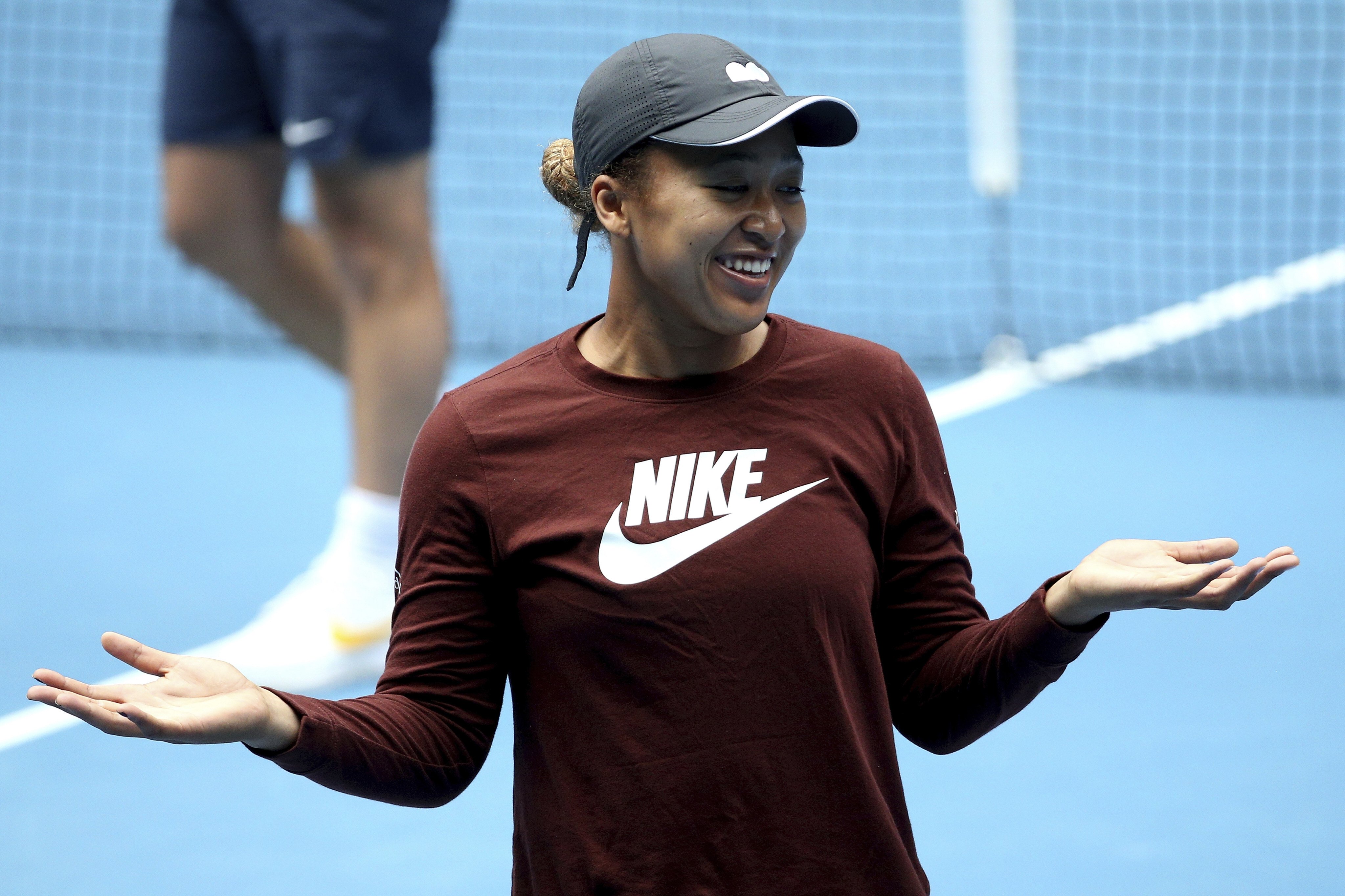 Naomi Osaka smiles during a practice session on Margaret Court Arena at the Summer Set tennis tournament ahead of the Australian Open in Melbourne. Photo: AP