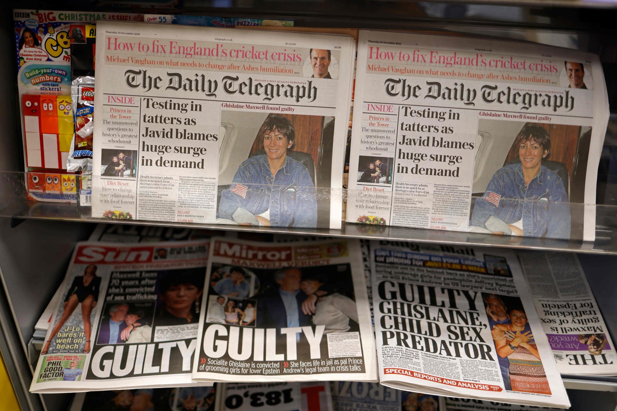 A selection of headlines from British newspapers is pictured in a store in London on December 30, the morning after a jury in New York found Ghislaine Maxwell guilty of sex trafficking charges. Photo: AFP