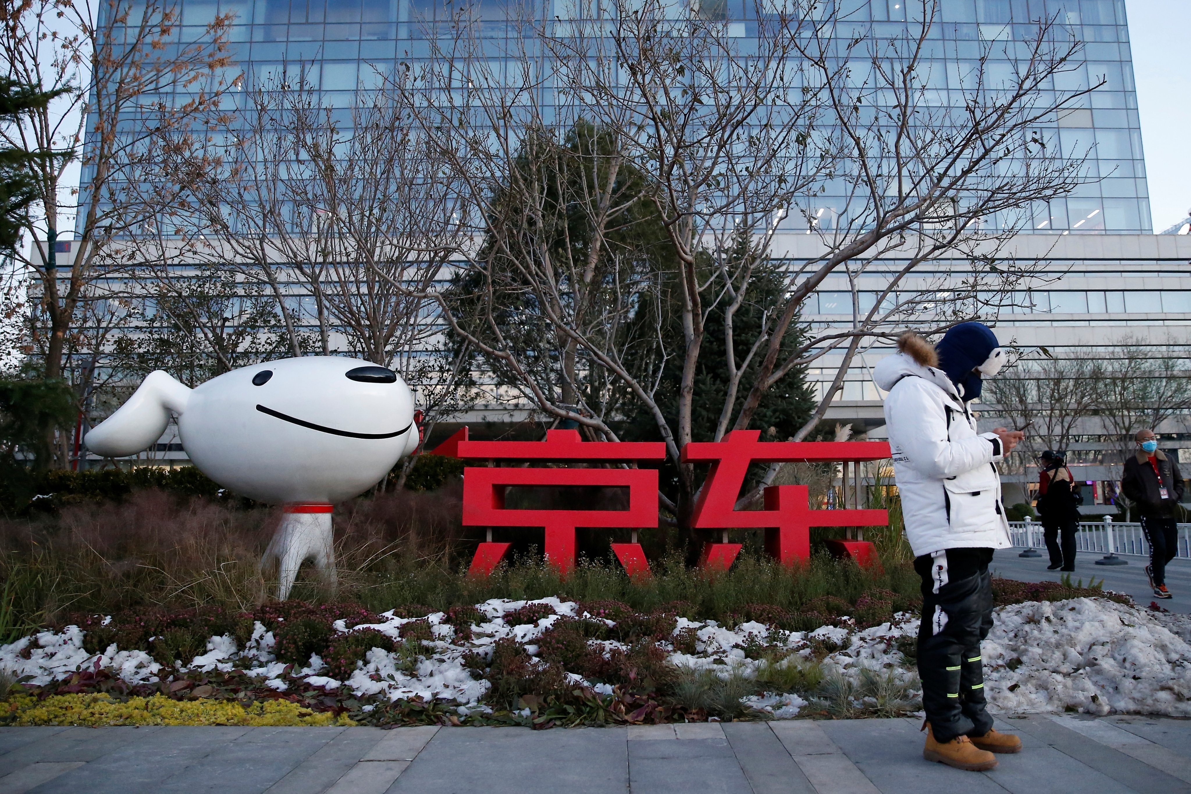 A man stands outside JD.com’s headquarters during an organised tour in Beijing on November 9, 2021. Photo: Reuters