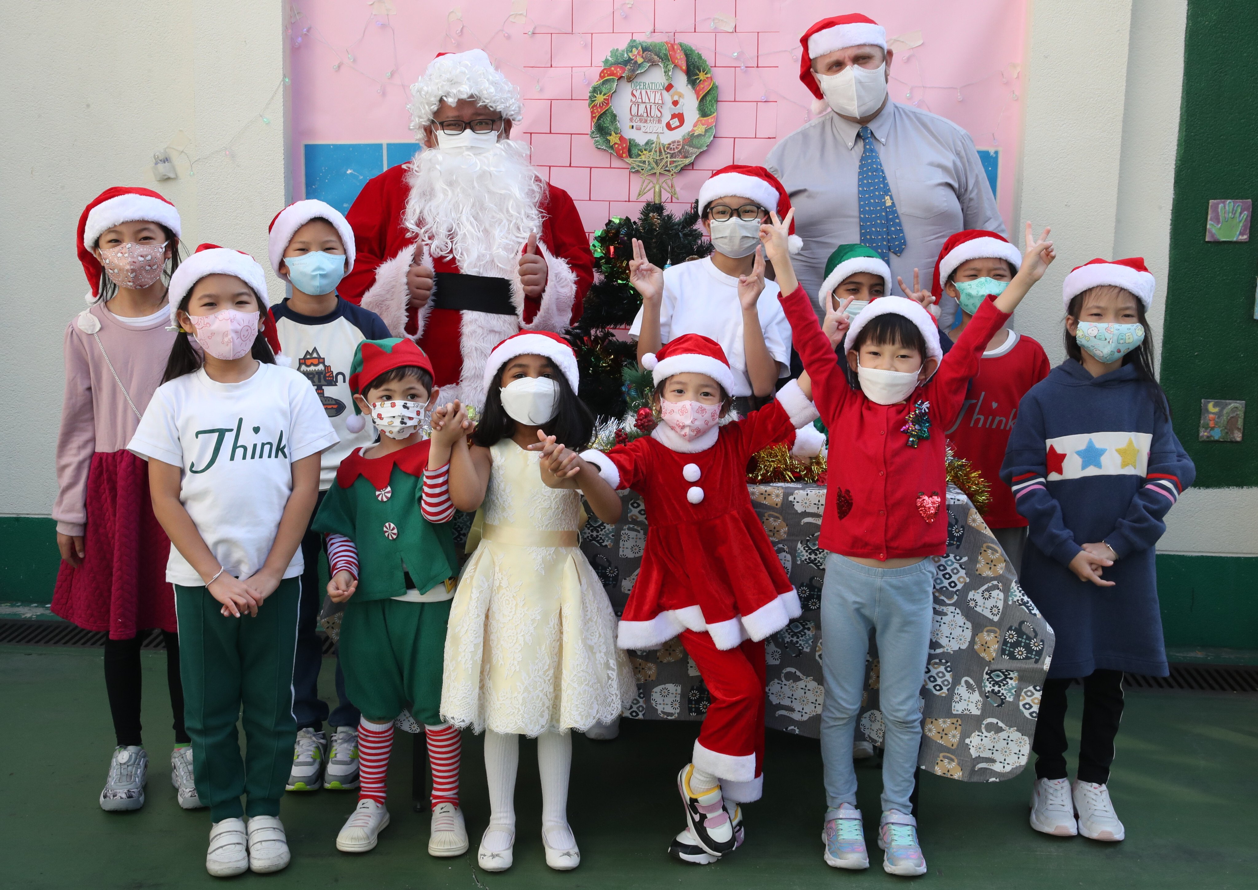 Santa with Robert Burns (back right), Think International School’s head of primary, and pupils. Photo: Edmond So