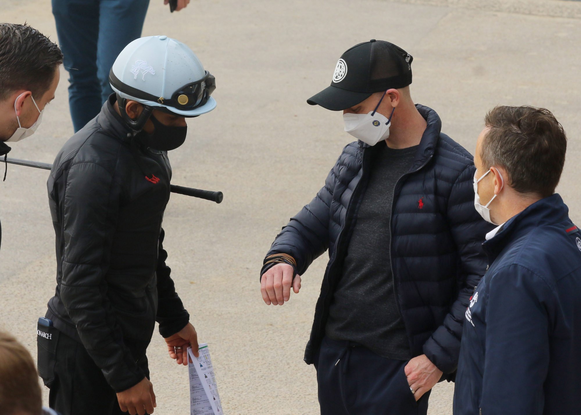 Jockey Zac Purton (right) shows Karis Teetan his fractured wrist.