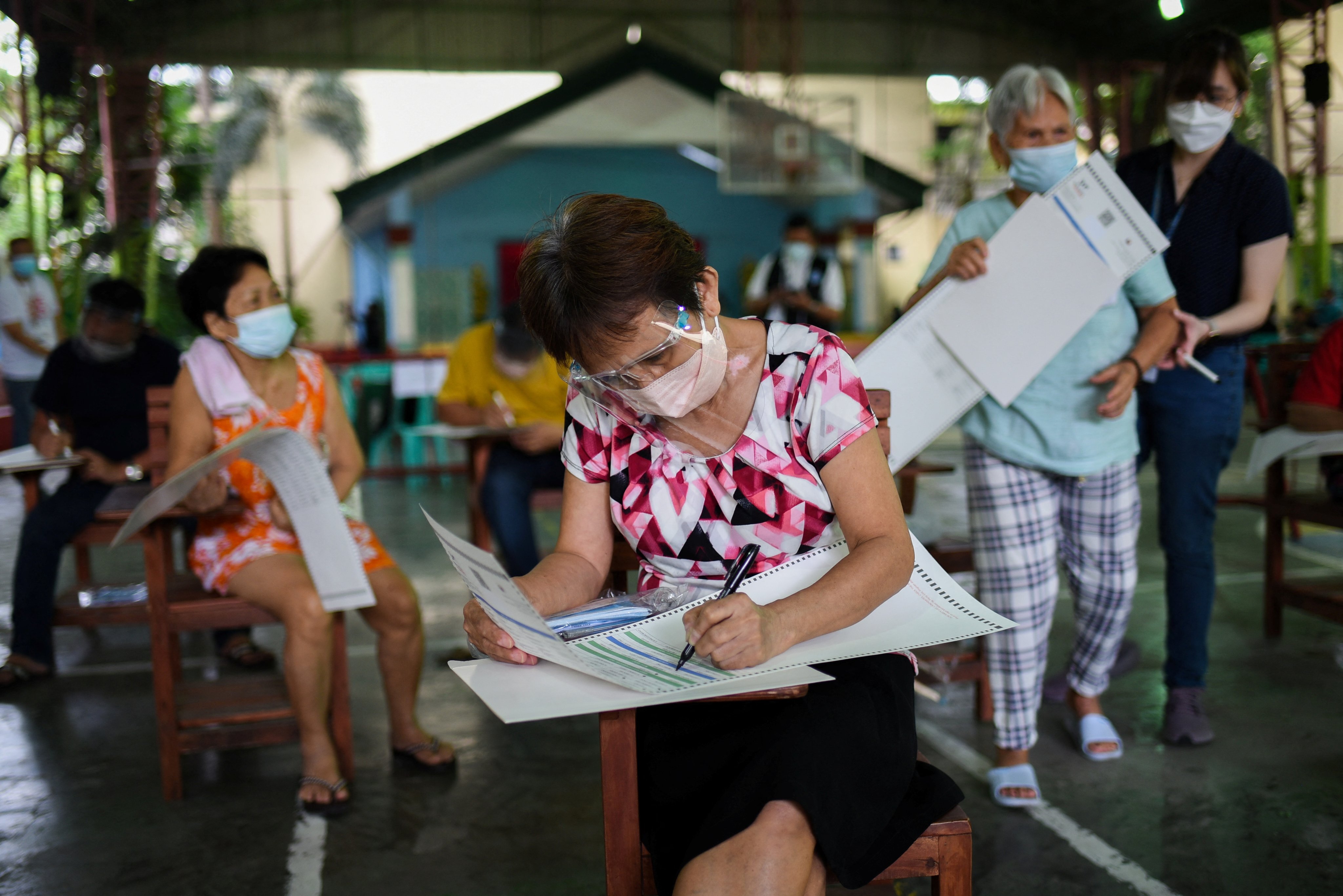 People pretend to cast their votes for the 2022 Philippine presidential election during a simulation exercise in Metro Manila last month. Photo: Reuters