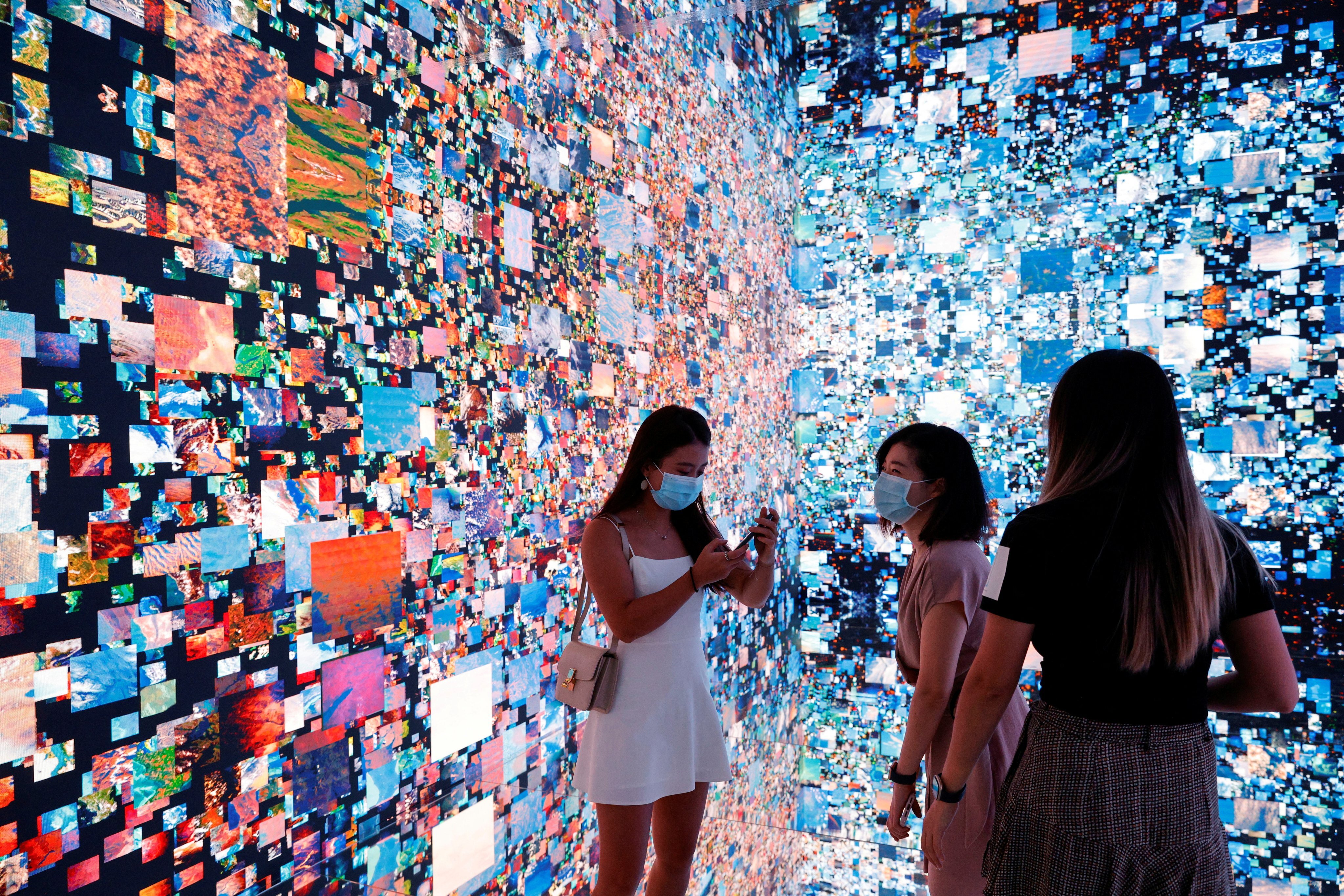 Visitors pictured in front of an immersive art installation titled “Machine Hallucinations – Space: Metaverse” on September 30, 2021. The piece by artist Refik Anadol was converted into an NFT and auctioned online at Sotheby’s, at the Digital Art Fair, in Hong Kong. Photo: Reuters
