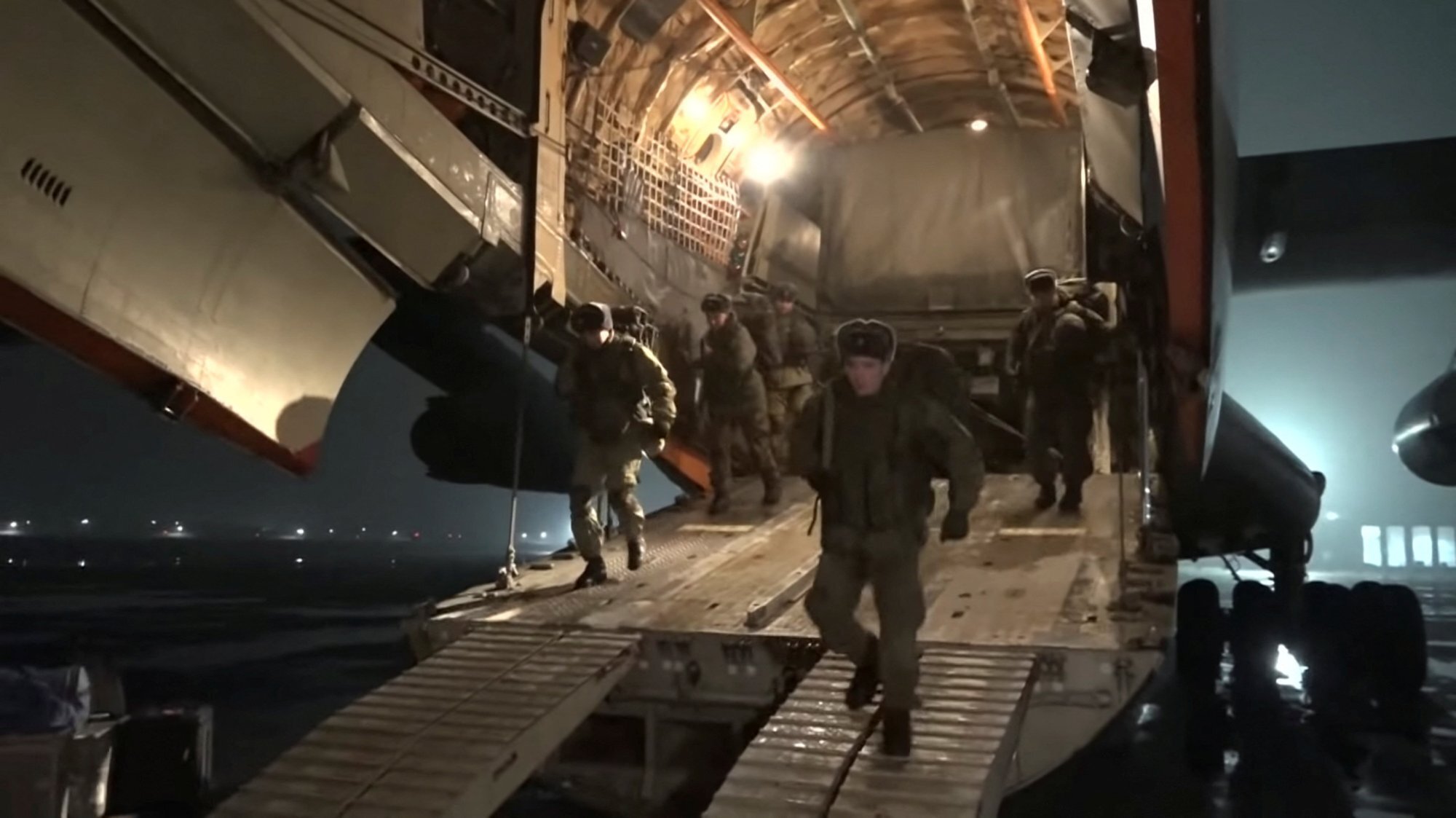 Russian service members disembark from a military aircraft as part of a peacekeeping mission from the Collective Security Treaty Organisation amid mass protests in Almaty and other Kazakh cities, at an airfield in Kazakhstan. This still image is from a video released by Russia’s Defence Ministry on January 8. Photo: Handout via Reuters