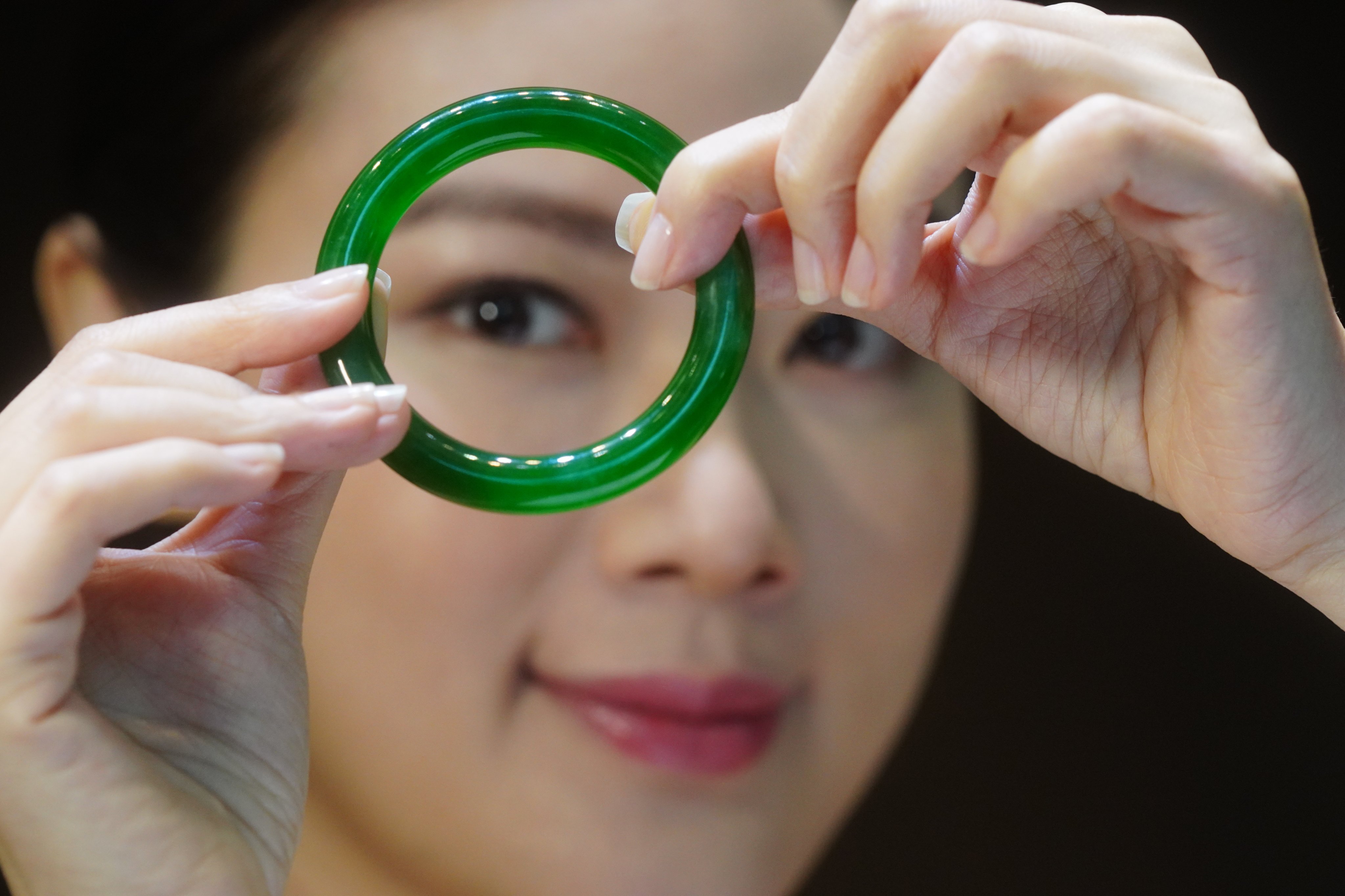 A model displays an Exceptional Jadeite Bangle “Circle of Happiness” , during the media preview at Sotheby’s office at Admiralty. 24MAR21  SCMP / Sam Tsang
