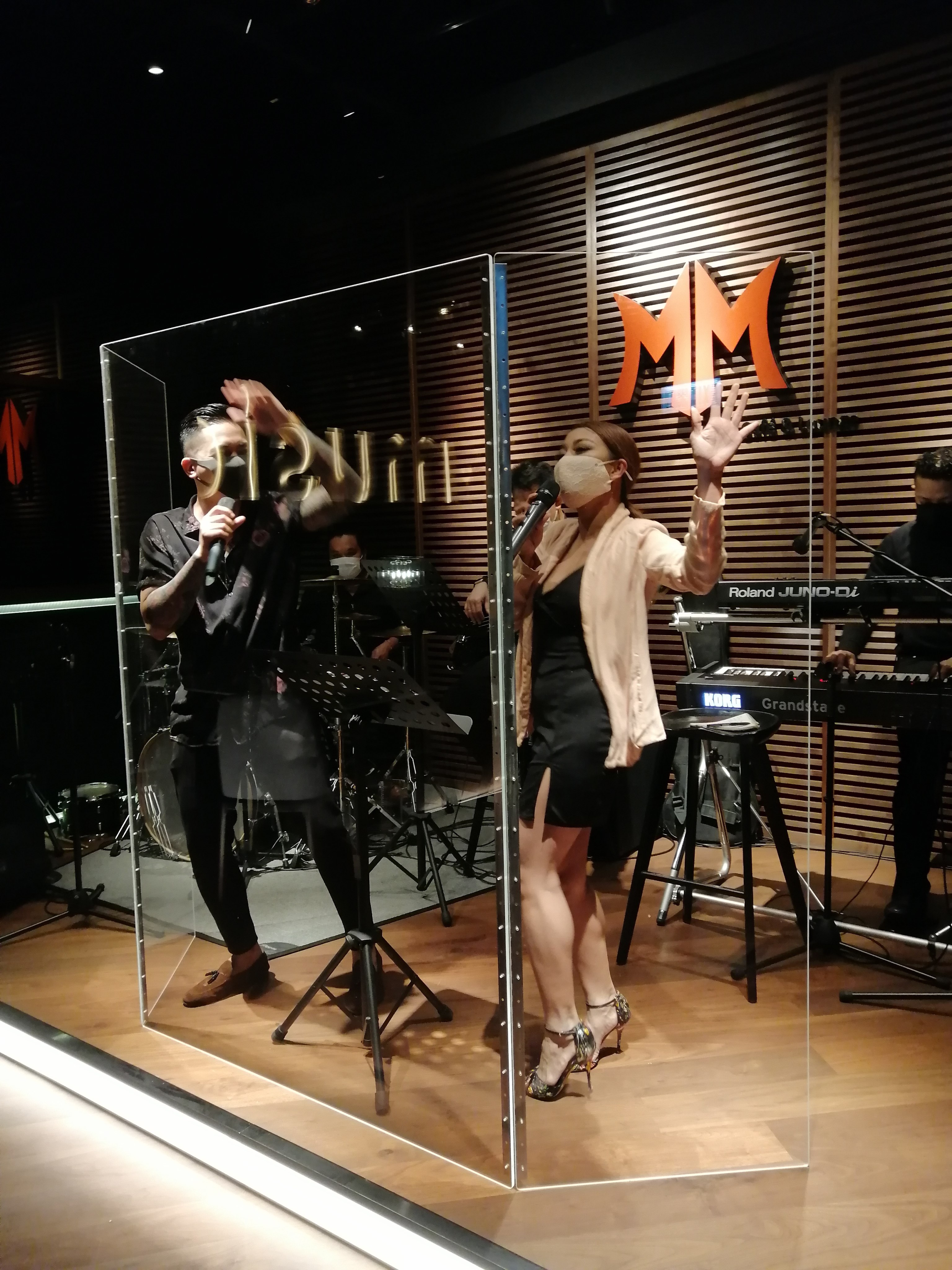 A performance at MM, a live music venue in Hong Kong’s Central that has since closed down. Government rules require singers to wear masks and perform behind a partition. Photo: Babe Tree