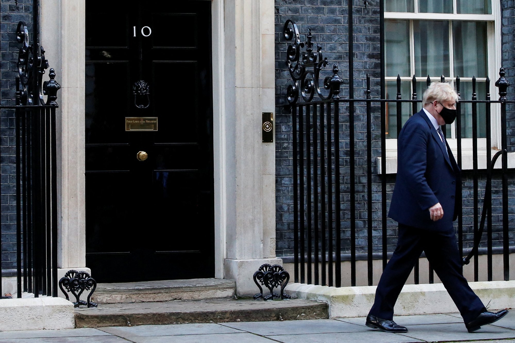 British Prime Minister Boris Johnson walks outside No. 10 Downing Street in London on Wednesday. Photo: Reuters