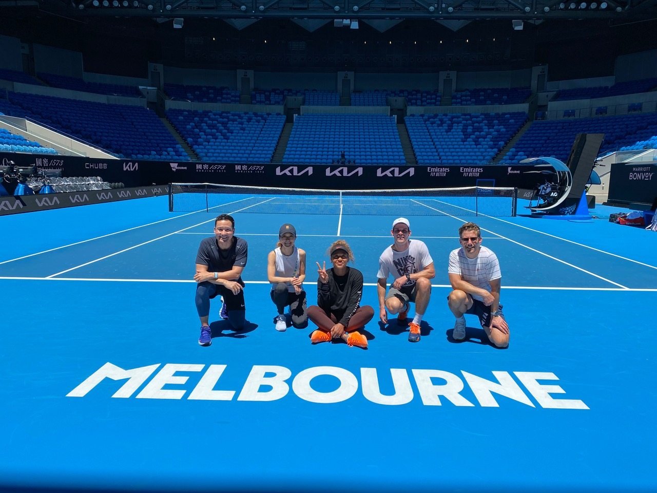 Reigning champion Naomi Osaka (centre) of Japan with team staff at a training session before the Australian Open in Melbourne. Photo: Handout   
