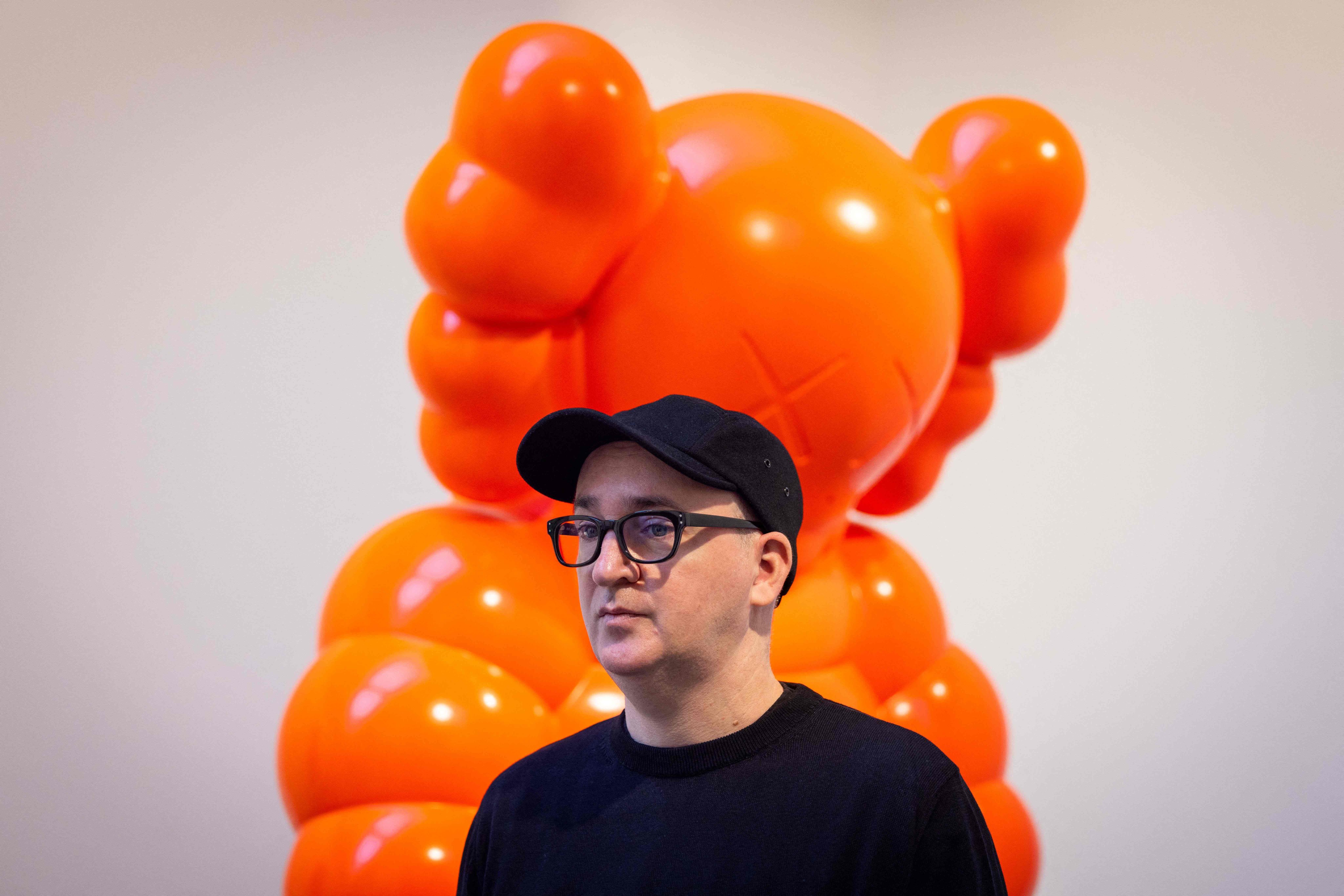 US artist Kaws with his artwork Kaws What Party at a preview of his exhibition at the Serpentine Gallery in London. Photo: Tolga Akmen/AFP