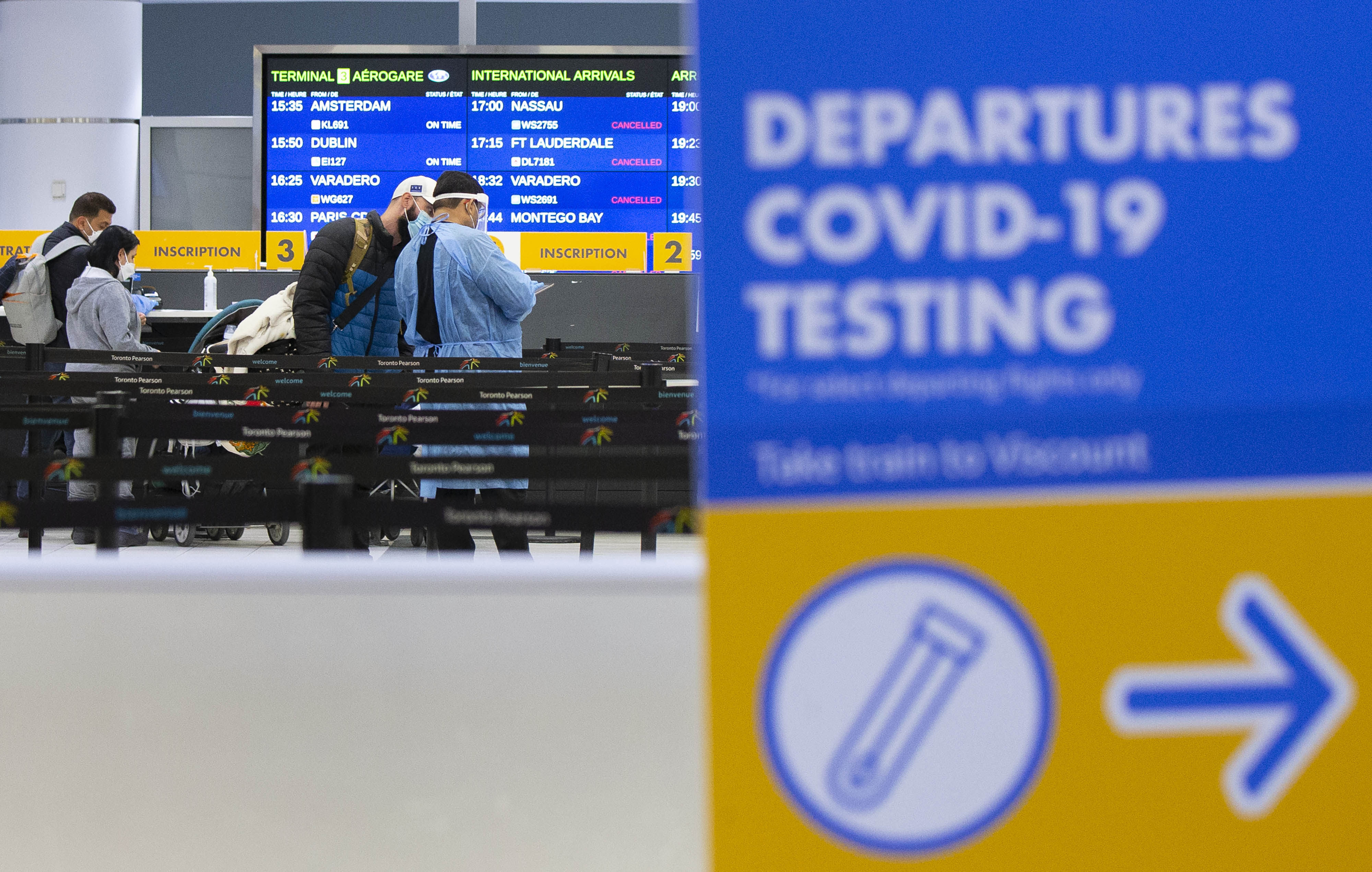 A medical worker talks to a traveller at a Covid-19 testing site in Toronto’s international airport on Monday.  Photo: Xinhua