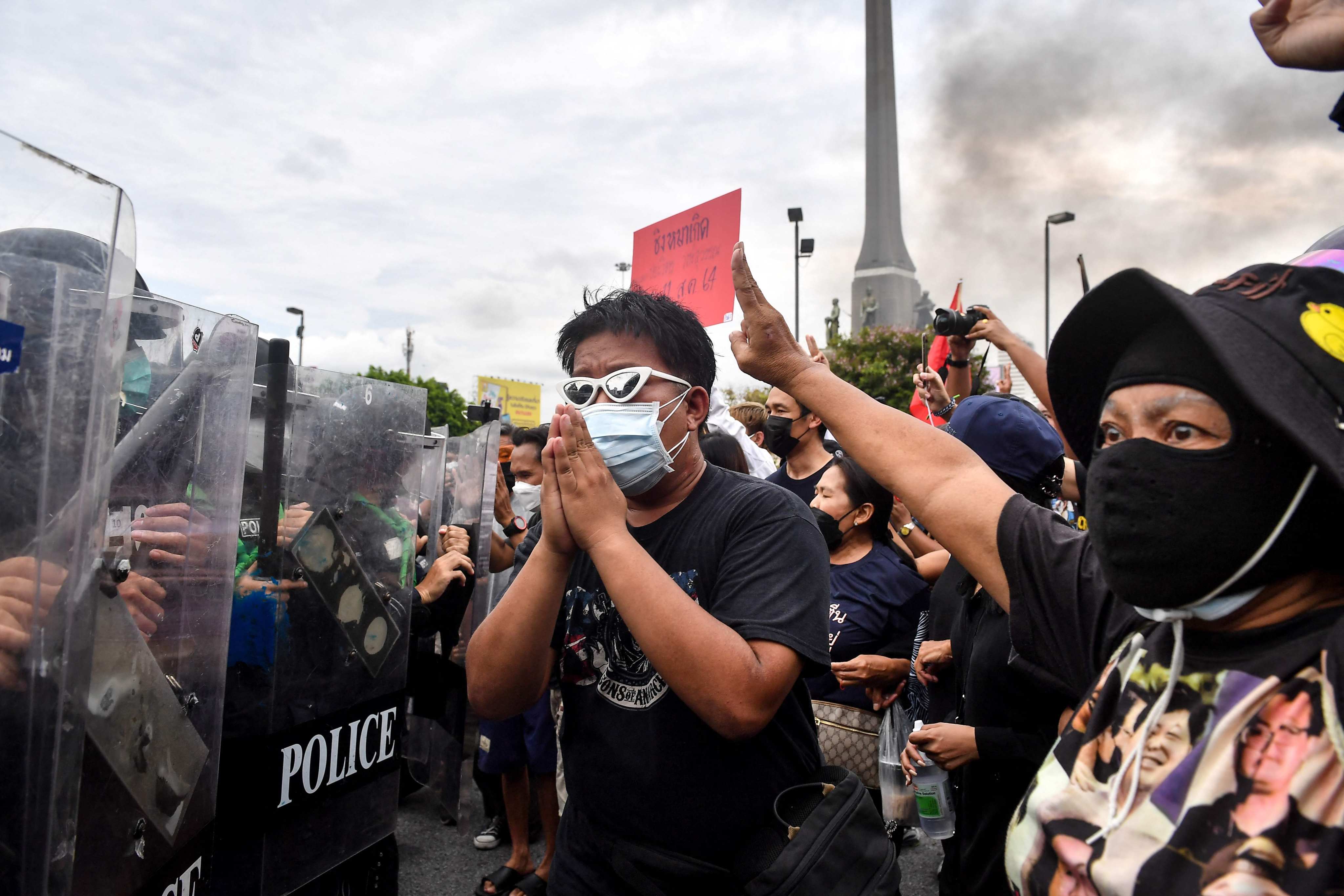 Pro-democracy protesters face a line of riot police at a protest calling for Thai Prime Minister Prayuth Chan-ocha to resign over the government’s handling of Covid-19, in Bangkok on August 11. Worldwide, many feel a greater sense of scepticism and discontent towards the establishment. Photo: AFP