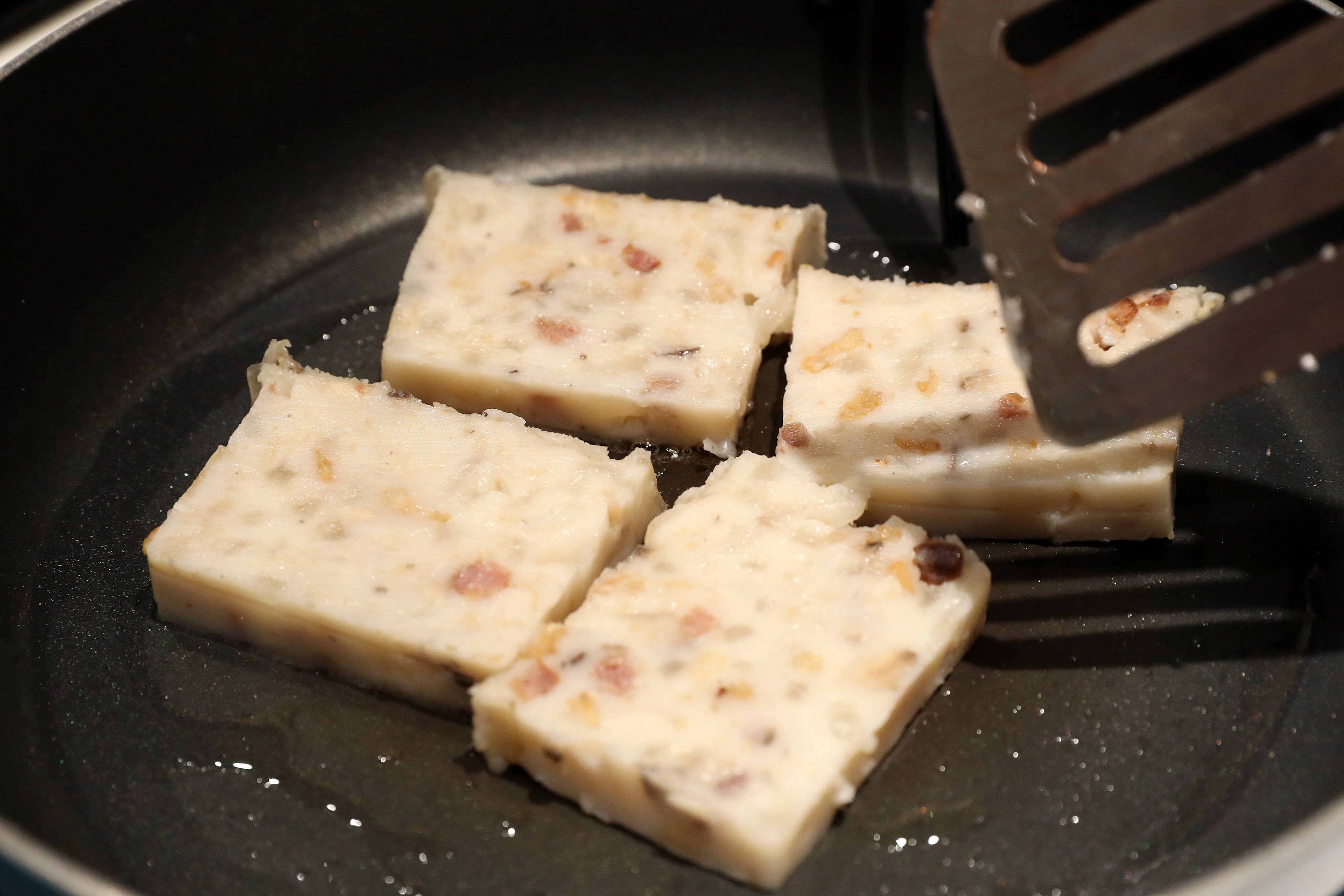 Loh bok goh - steamed radish cake - from Dashijie in Hong Kong being pan-fried for serving. Photo: SCMP/K. Y. Cheng