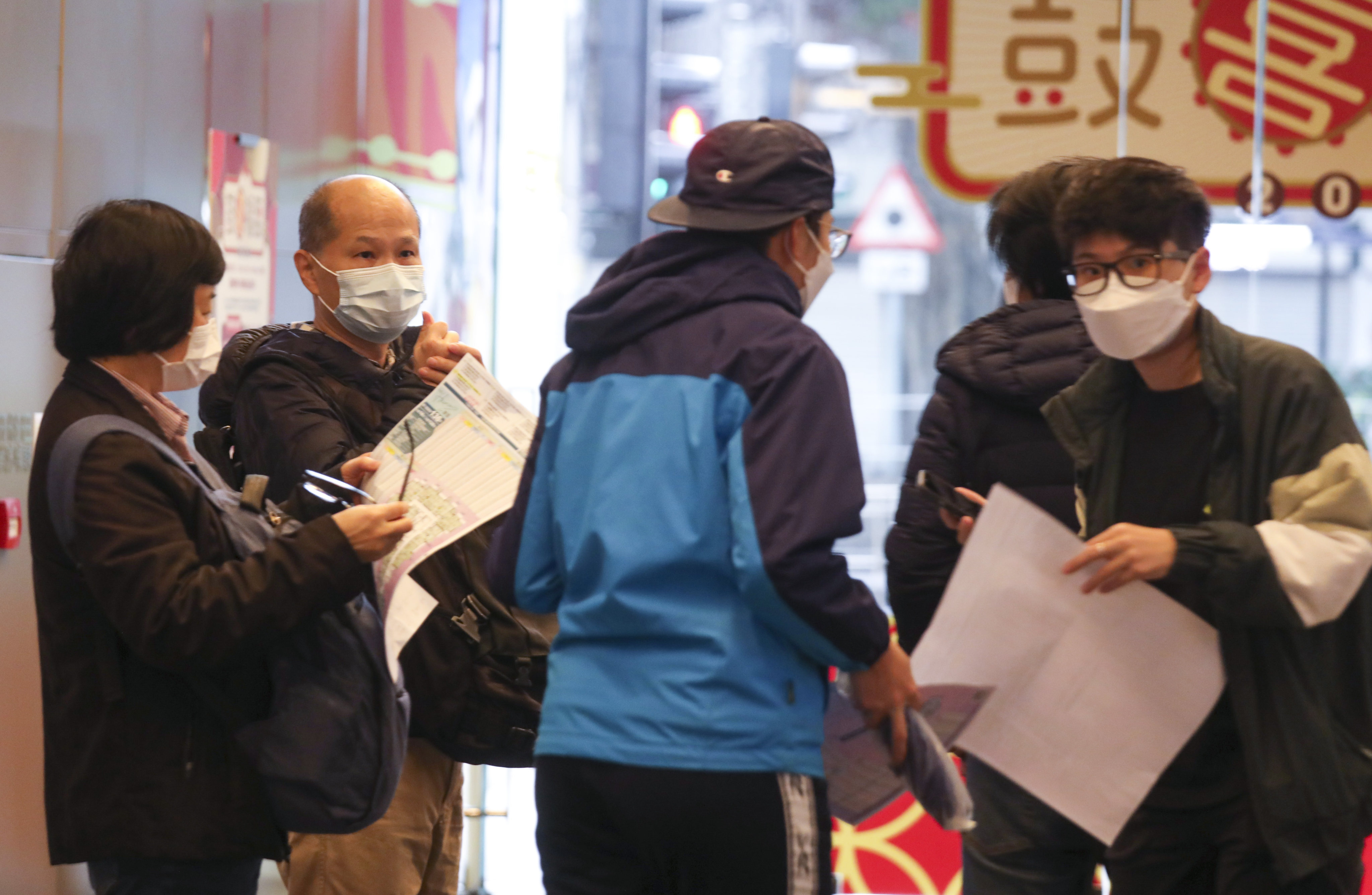 Buyers queueing for The Harmonie residential property project in Cheung Sha Wan at Henderson Land Development’s sales office at the Mira Place One in Tsim Sha Tsui on 22 January 2022. Photo: Xiaomei Chen