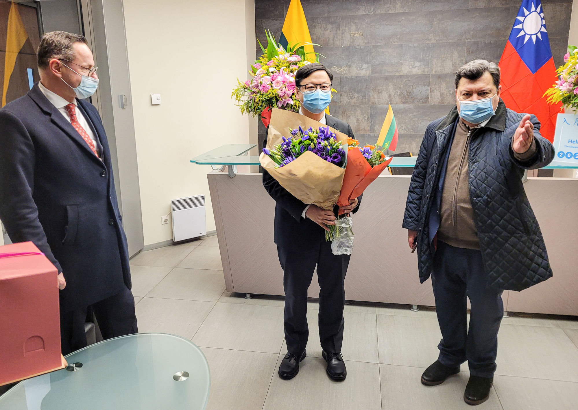 Žygimantas Pavilionis (left), head of the Lithuanian legislature’s foreign affairs committee, and Lithuanian lawmaker Emanuelis Zingeris (right) congratulate Eric Huang, head of Taiwanese Representative Office in Lithuania, on the opening of the de facto embassy in Vilnius on November 18. Photo: Finbarr Bermingham