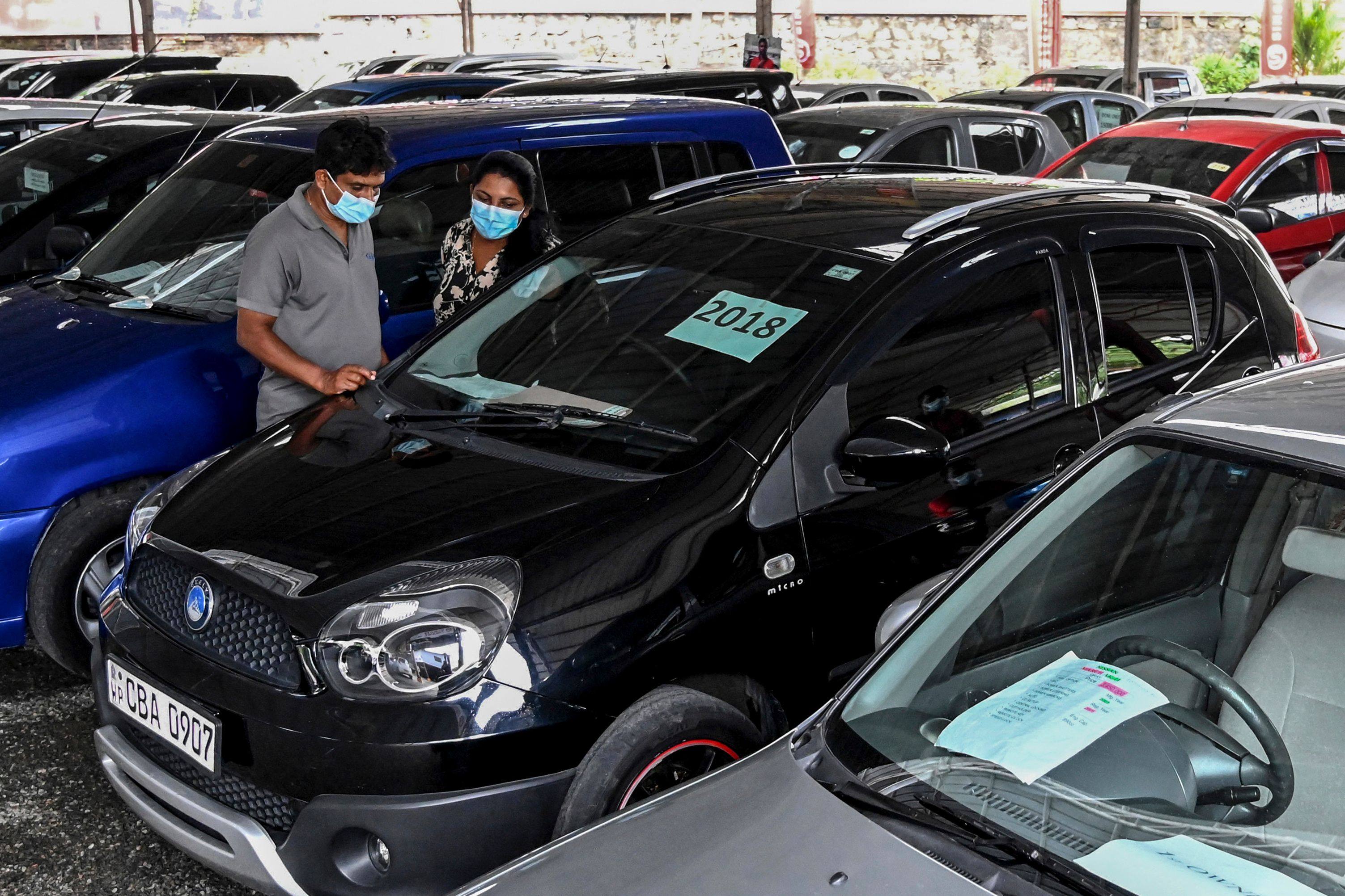Customers look at used cars displayed for sale at a showroom in Colombo’s Malabe, Sri Lanka. Photo: AFP