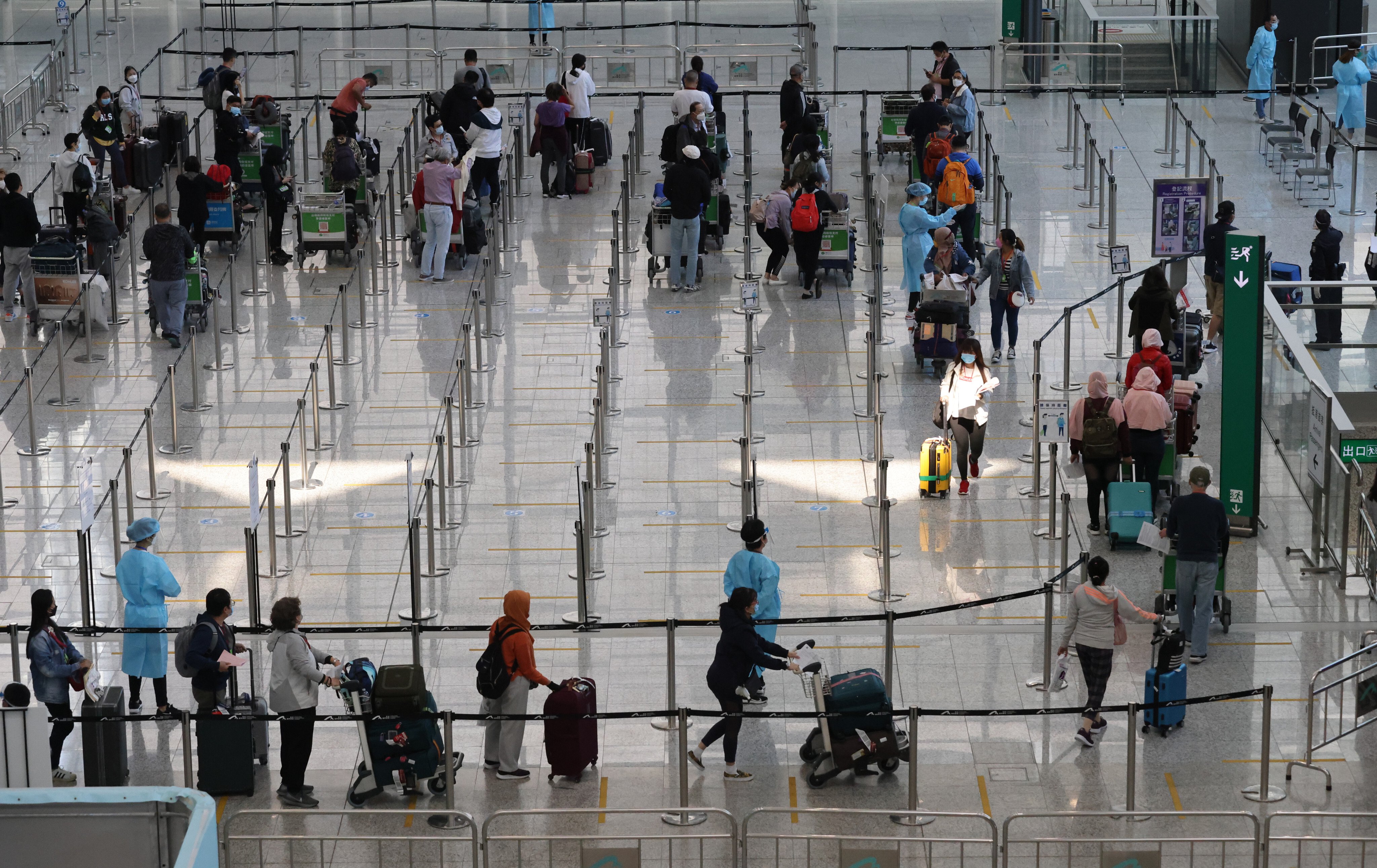 Inbound travellers arrive at Hong Kong International Airport on November 14, 2021, before being transported to quarantine hotels in the city. Photo: May Tse