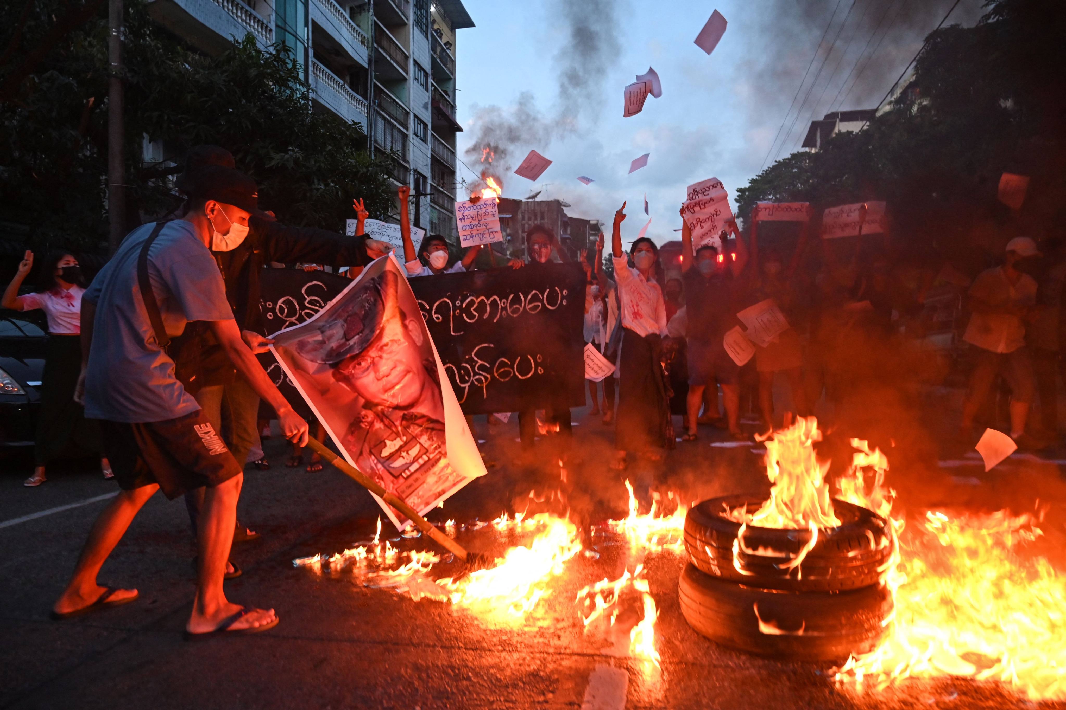 Protesters burn a picture of Myanmar’s junta chief Min Aung Hlaing during a demonstration in Yangon in November against the military coup. Photo: AFP