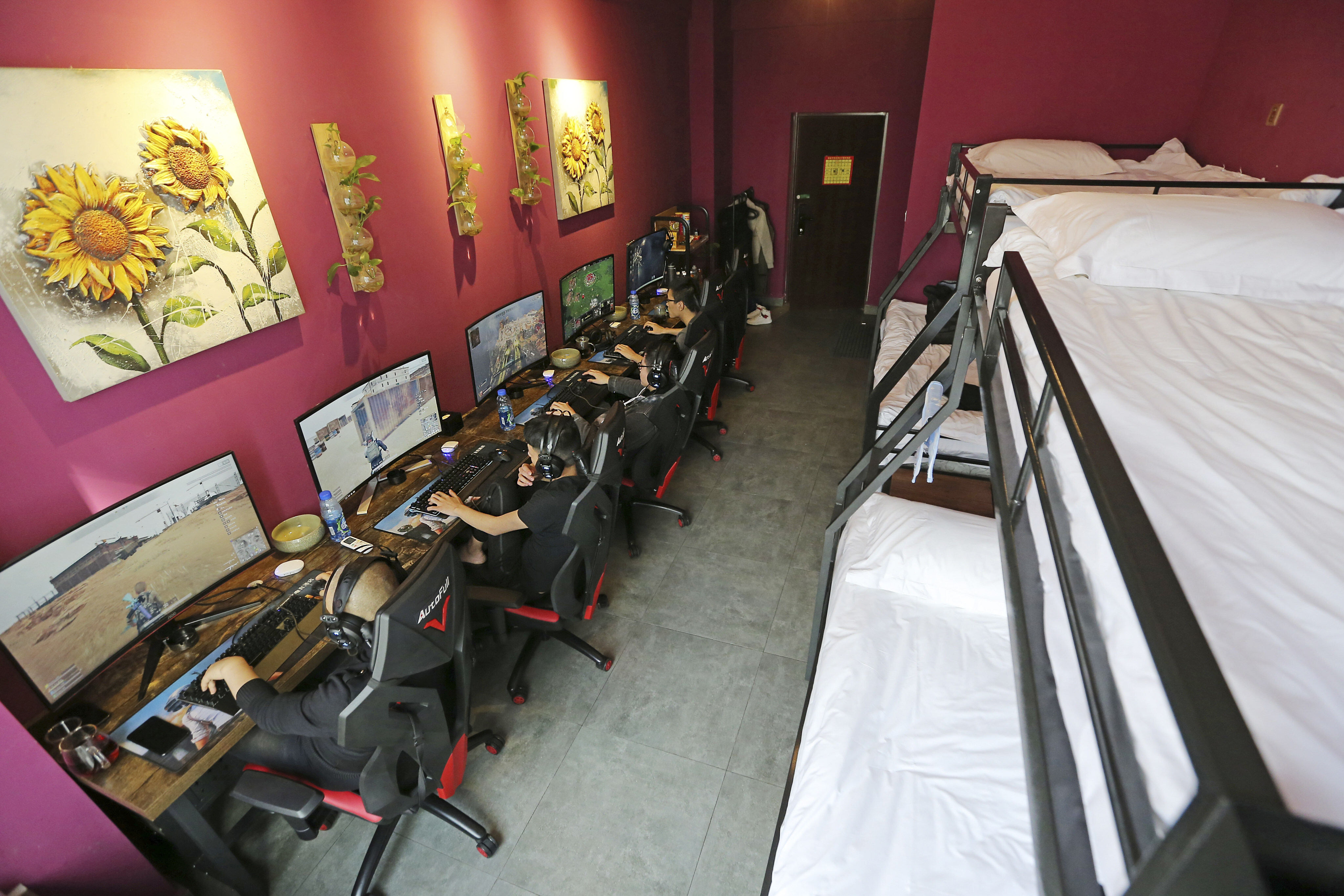 Young men play online video games in an esports hotel in Chengdu in southwest China. Photo: Imaginechina