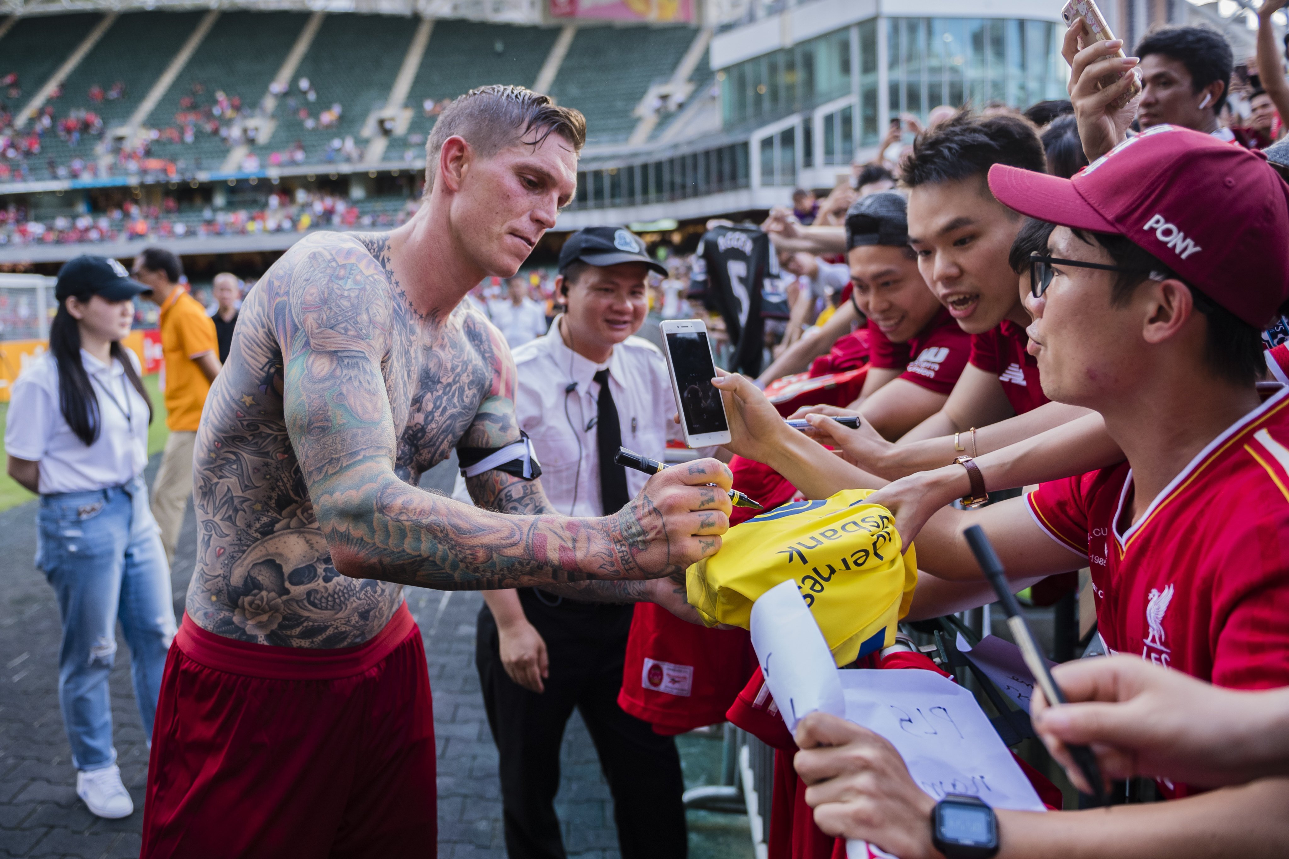Daniel Agger shows off his tattoos during a Liverpool alumni game at Hong Kong Stadium. Photo: Getty Images