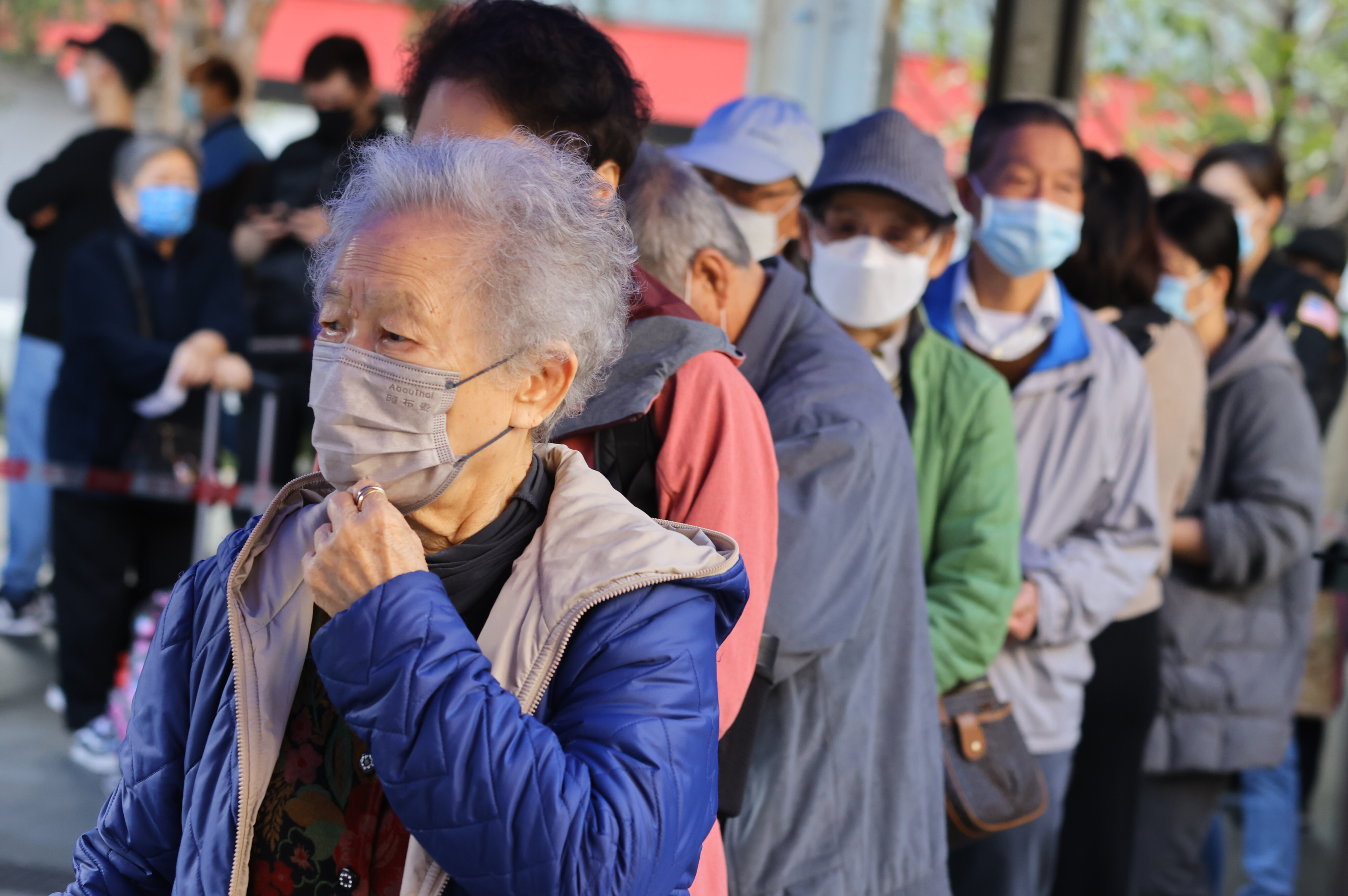 Senior citizens queue up to get vaccinated at Wong Tai Sin Temple Square on January 8. The government should consider the holistic needs of older Hongkongers before implementing policies like the health care voucher scheme for the elderly. Photo: Dickson Lee