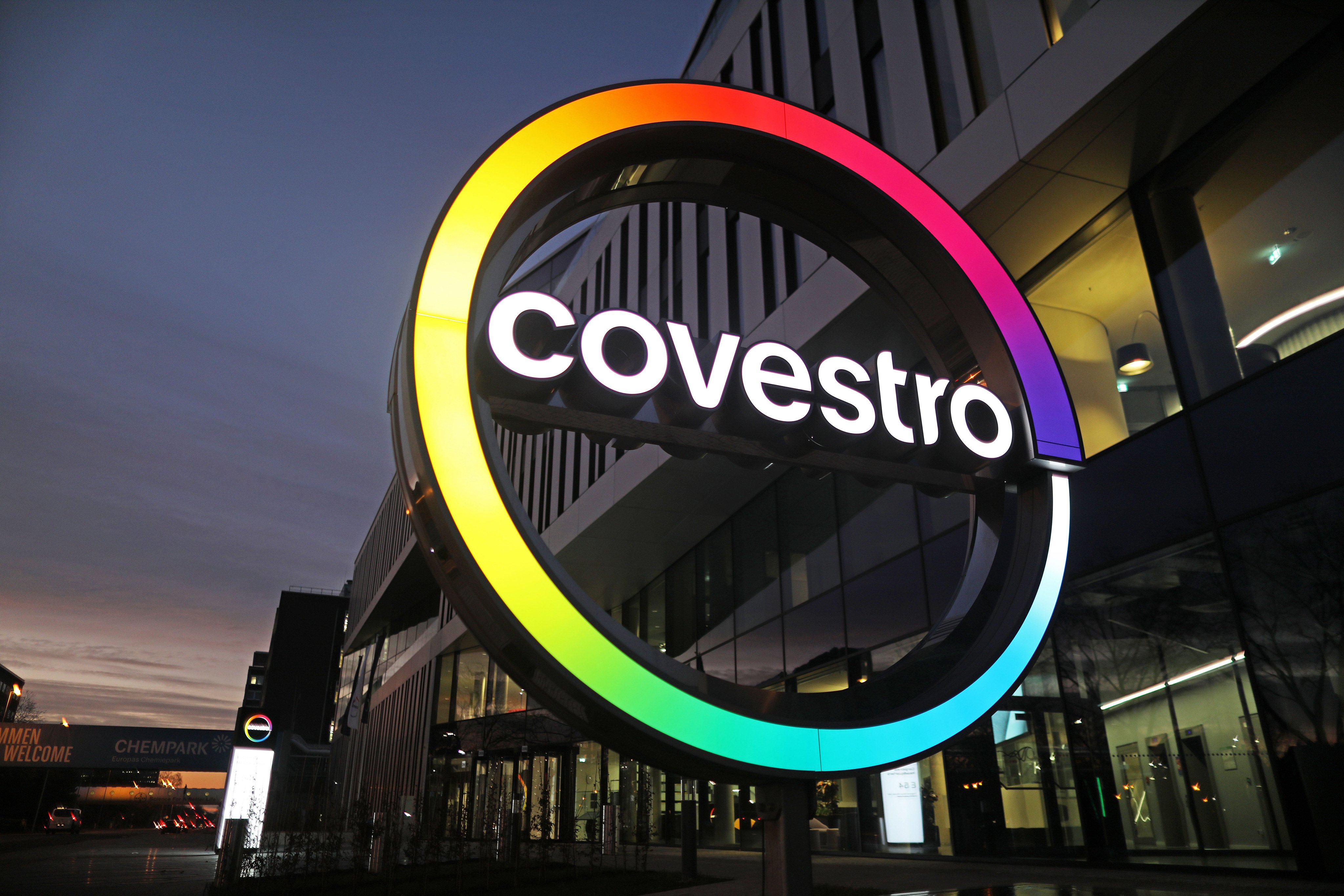 The logo of plastics company Covestro is illuminated in front of its corporate headquarters in Leverkusen, Germany.  Photo: DPA